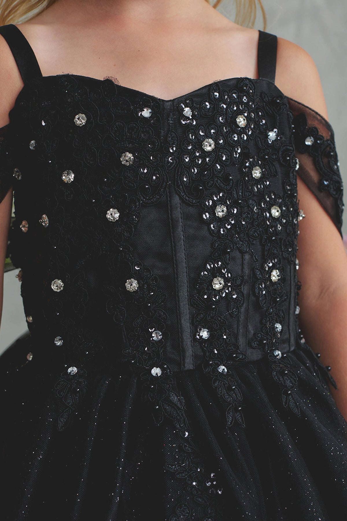Seen from up close, this Black kids pageant dress displays sequin-trimmed lace over structured seams.