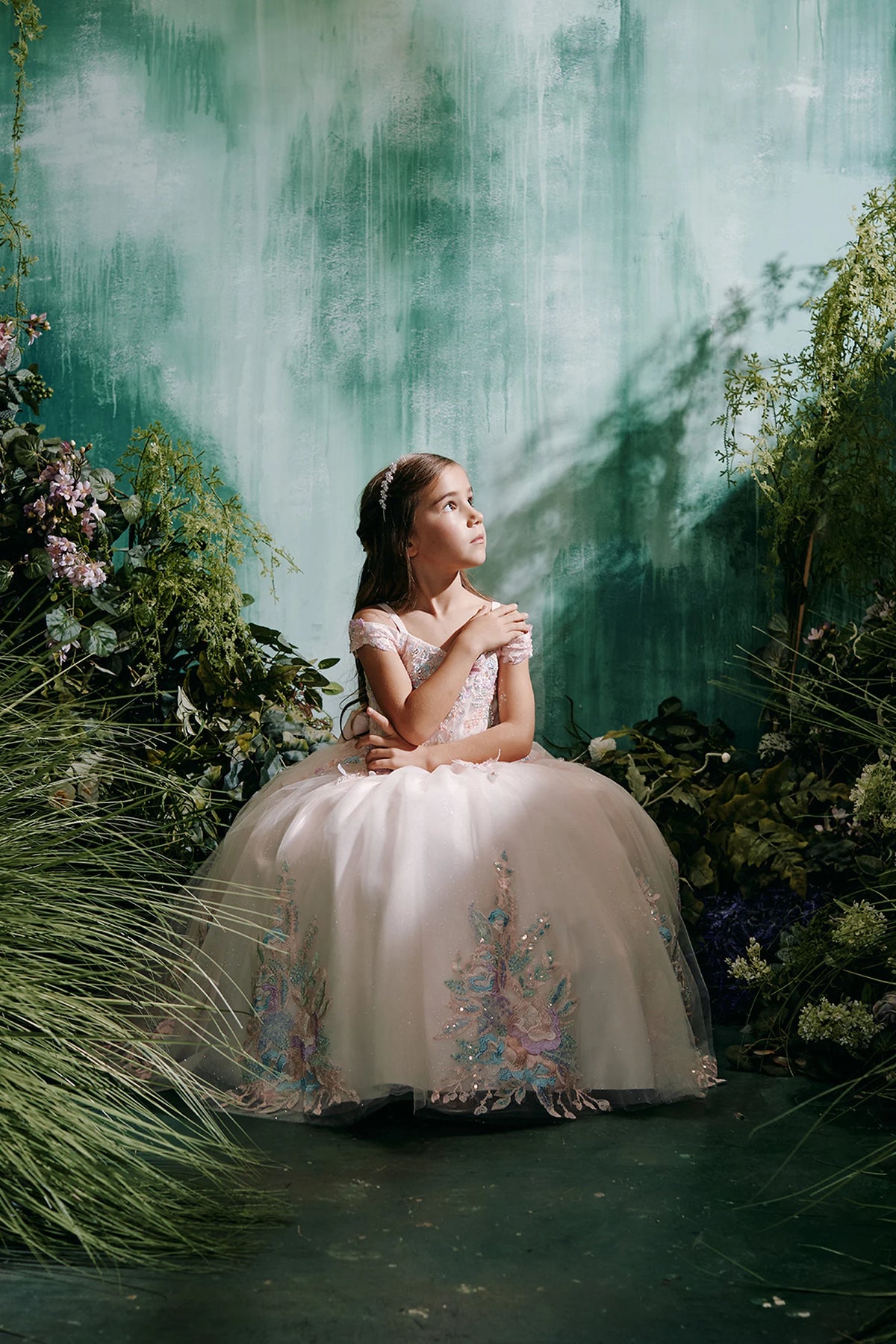 Seen from the front, this Blush kids pageant dress displays multicolor floral lace.