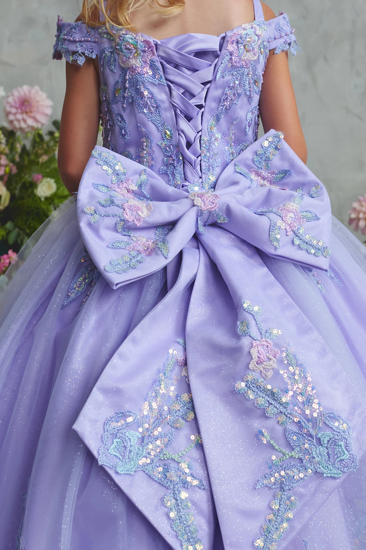 Seen from up close, this Lilac kids pageant dress displays an oversized bow across the back waist.