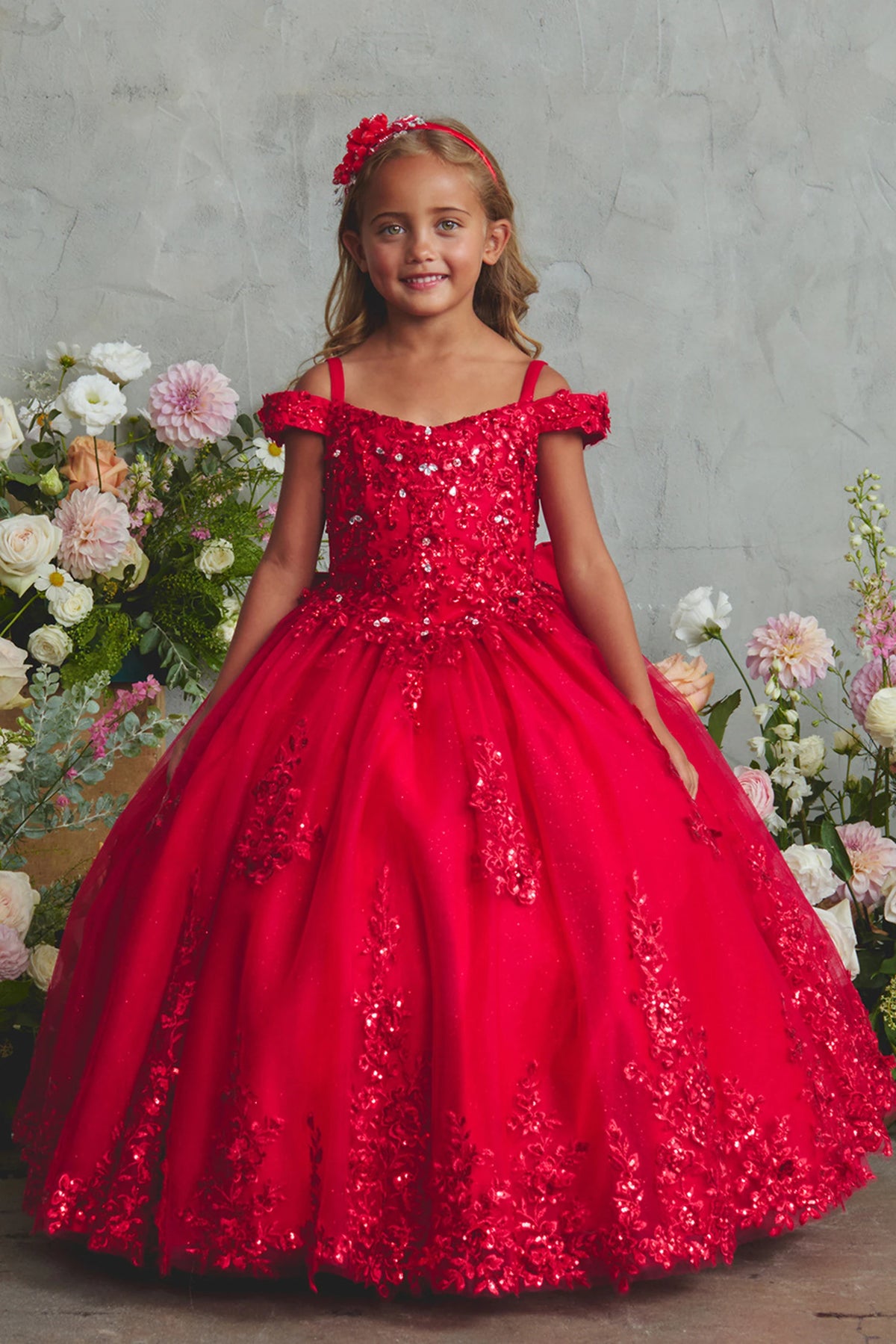 Red kids pageant dress featuring lace appliques on a glitter tulle skirt.