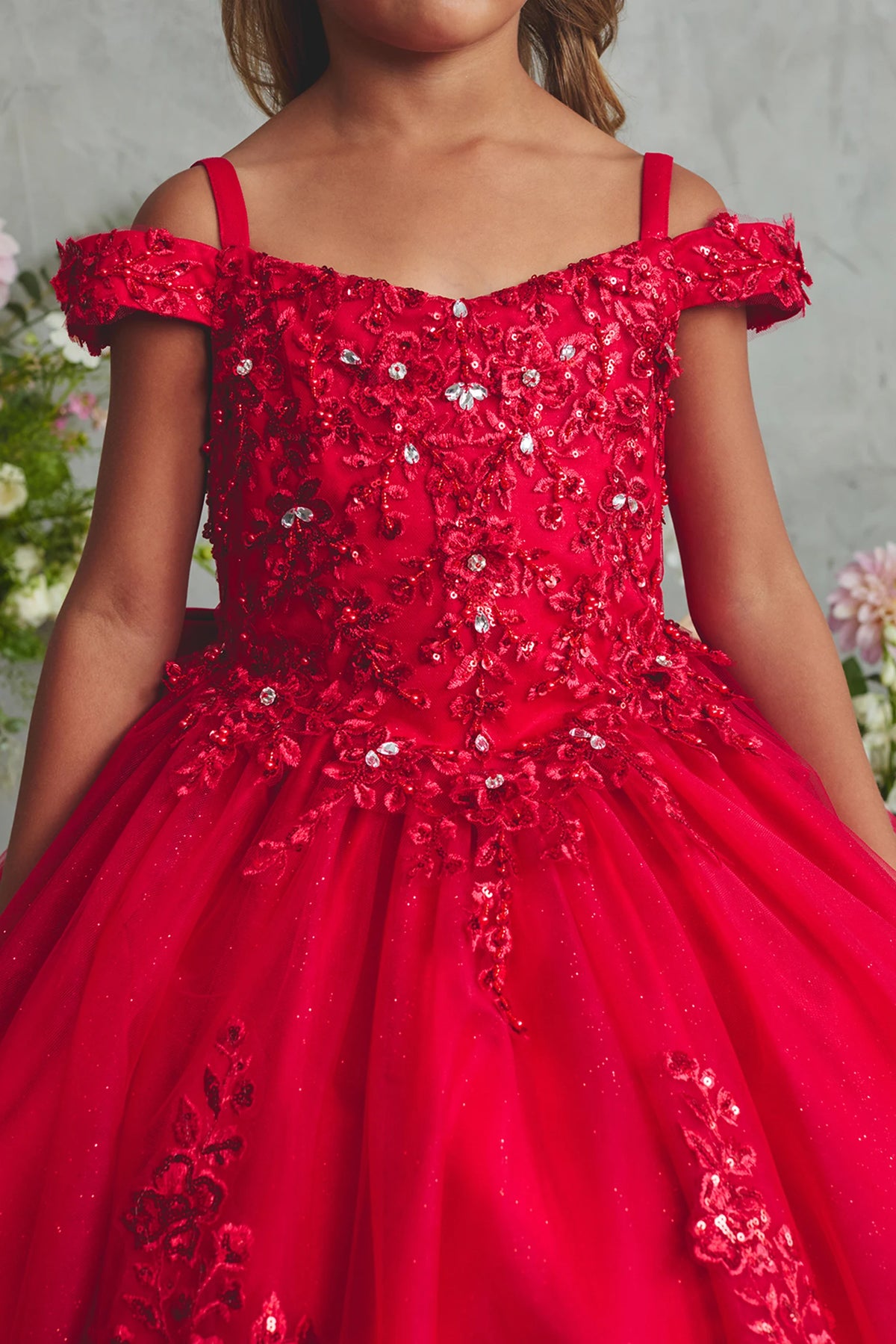 On the Red kids pageant dress, the detailing includes beaded lace across the bodice.