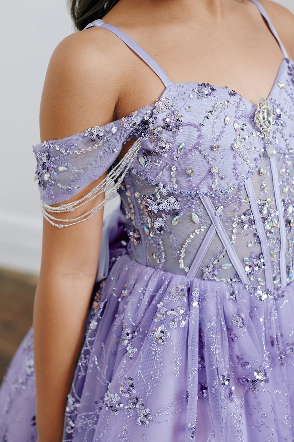 Visible details on the Lilac kids pageant dress include beads and sequins over sheer bodice panels.