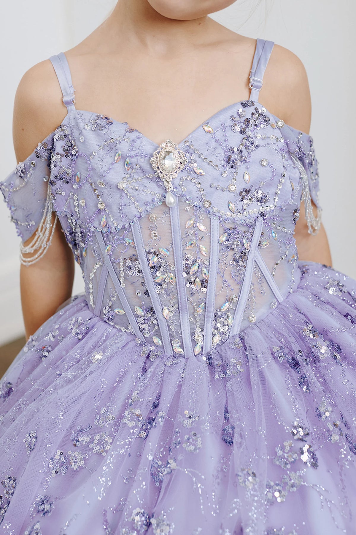 On the Lilac kids pageant dress, the detailing includes rhinestones over the structured bodice.