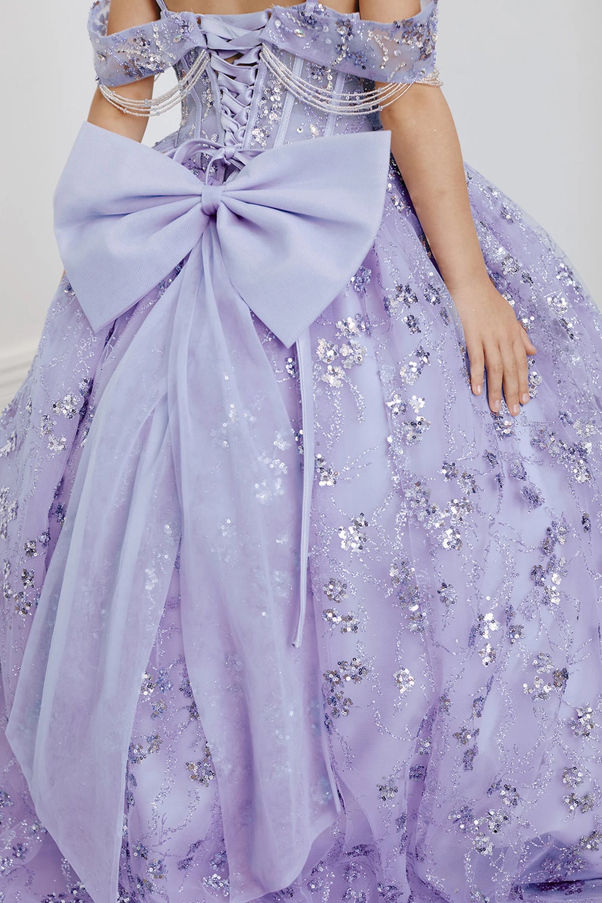Another view of the Lilac kids pageant dress shows a large bow above the glitter skirt.