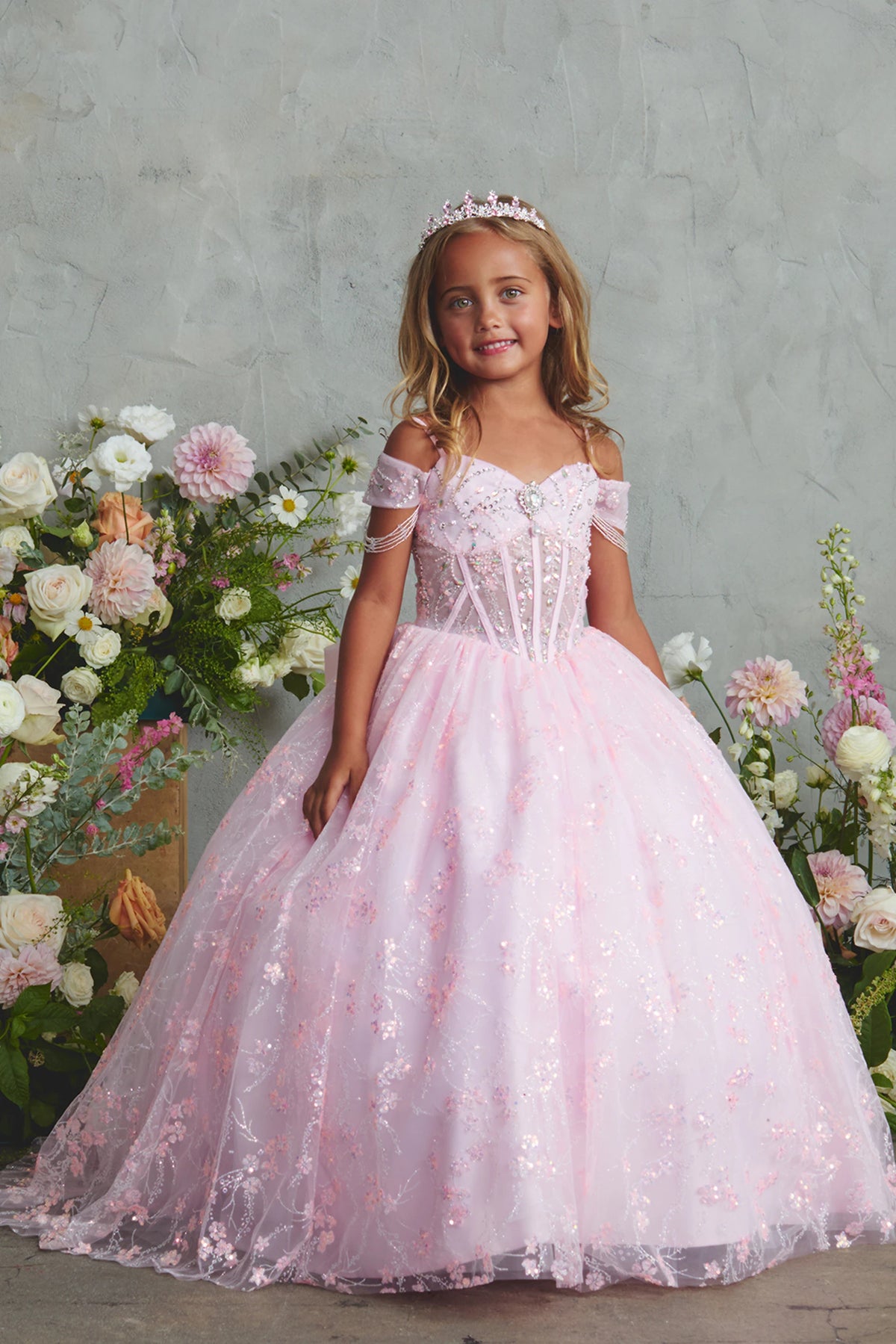 Pink kids pageant dress featuring beadwork over sheer bodice panels.