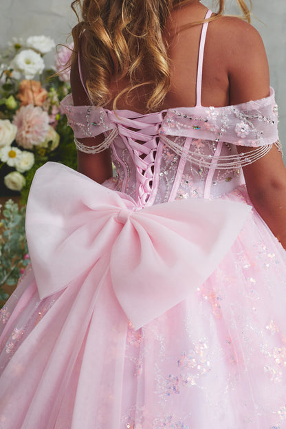 Seen from up close, this Pink kids pageant dress displays back lacing above a large bow.