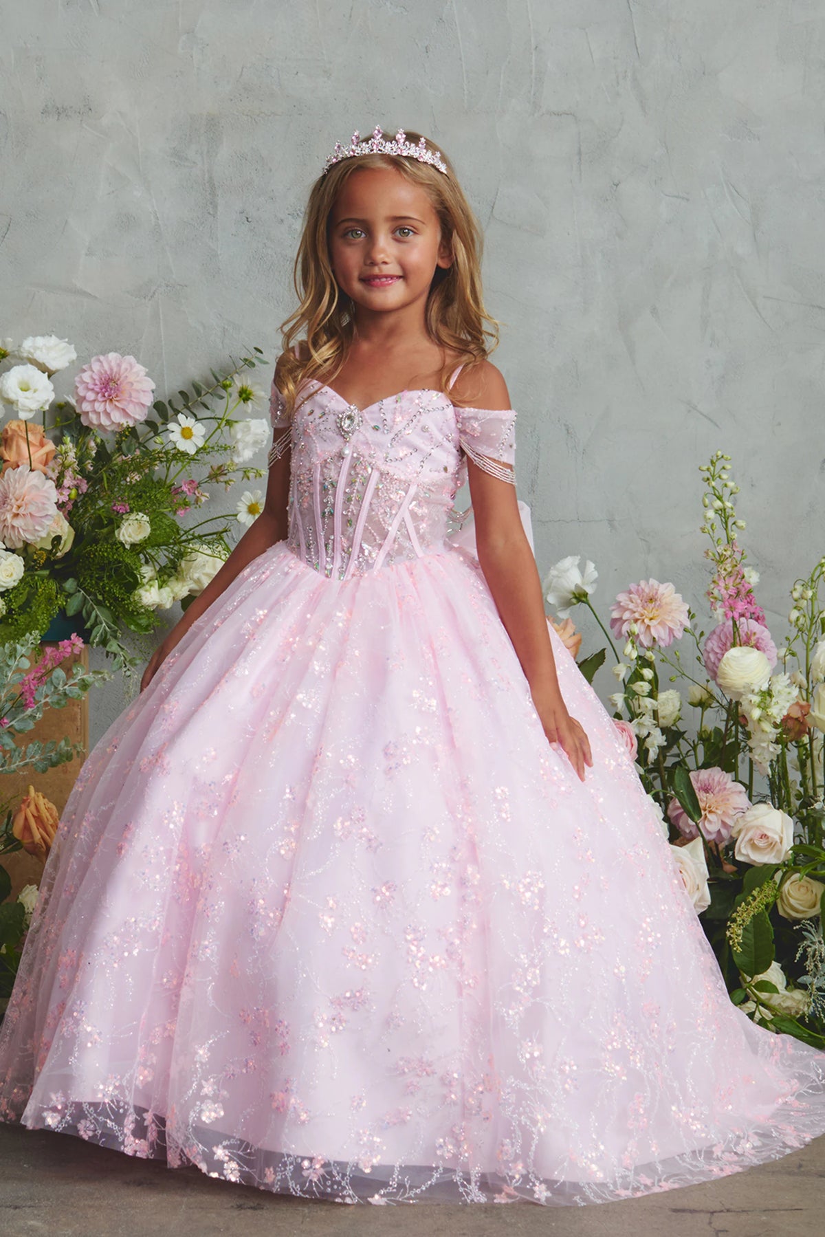 Showing beadwork over sheer bodice panels, the Pink kids pageant dress has a detailed finish.