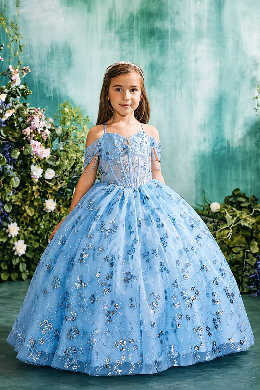 Sky blue pageant dress pairs floral glitter details with draped shoulder accents.