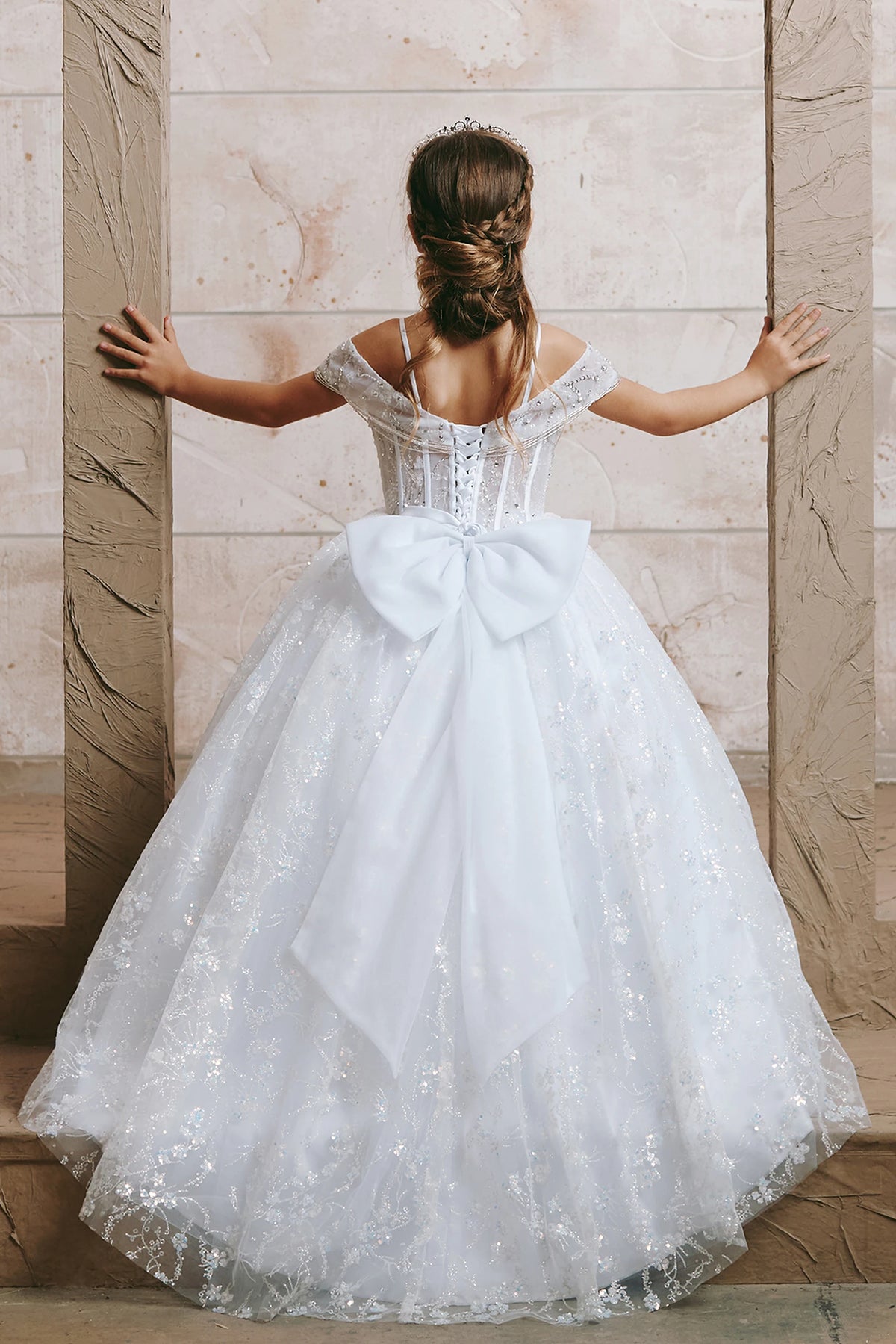 The White kids pageant dress has lace-up ties at the back.