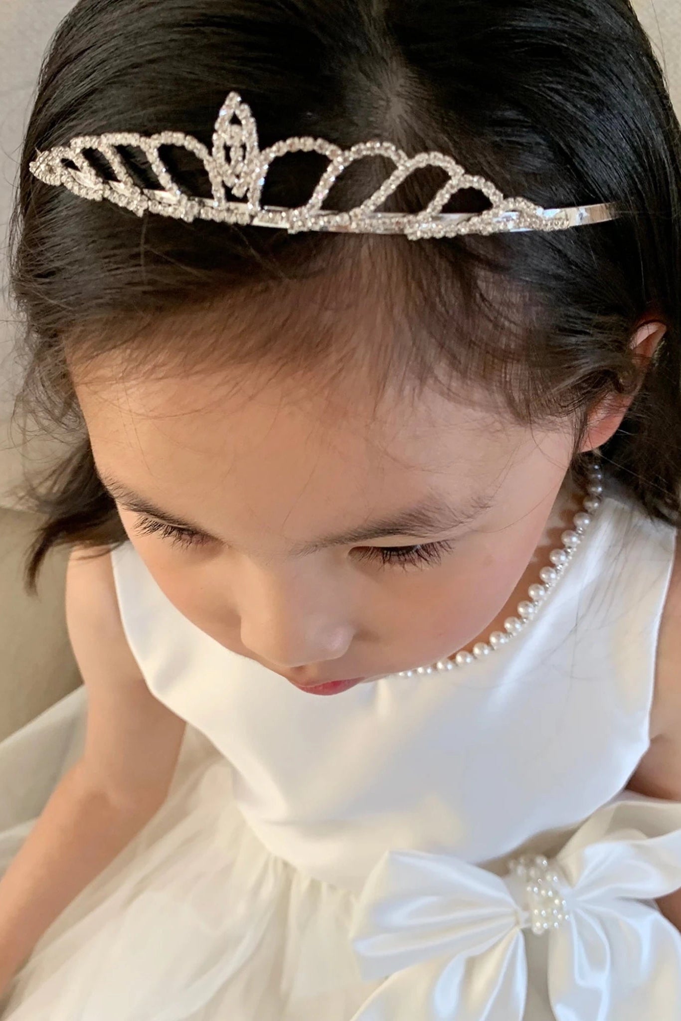 Front view of Ivory Pearl Neckline and Pearl detail Bow Satin and Tulle flower girl dress.