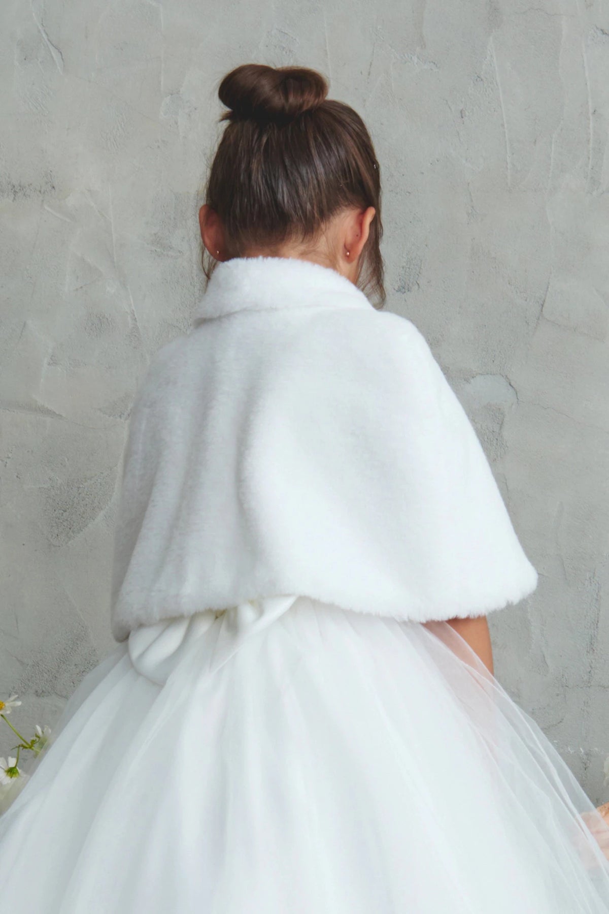 Back view of the White faux fur cape showing its rounded collar and draped shape.