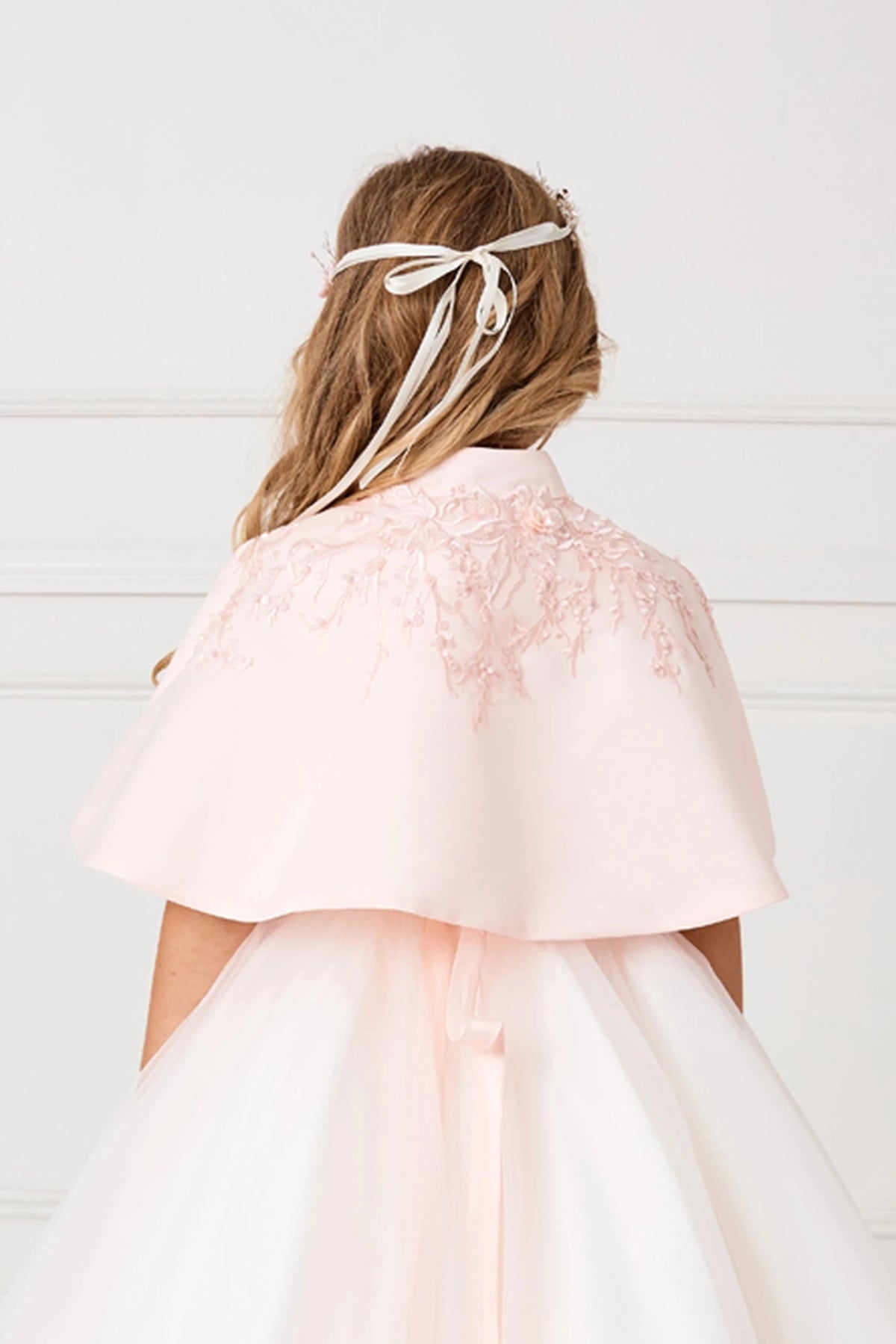 Floral appliqué decorates the back neckline of the Blush satin cape.