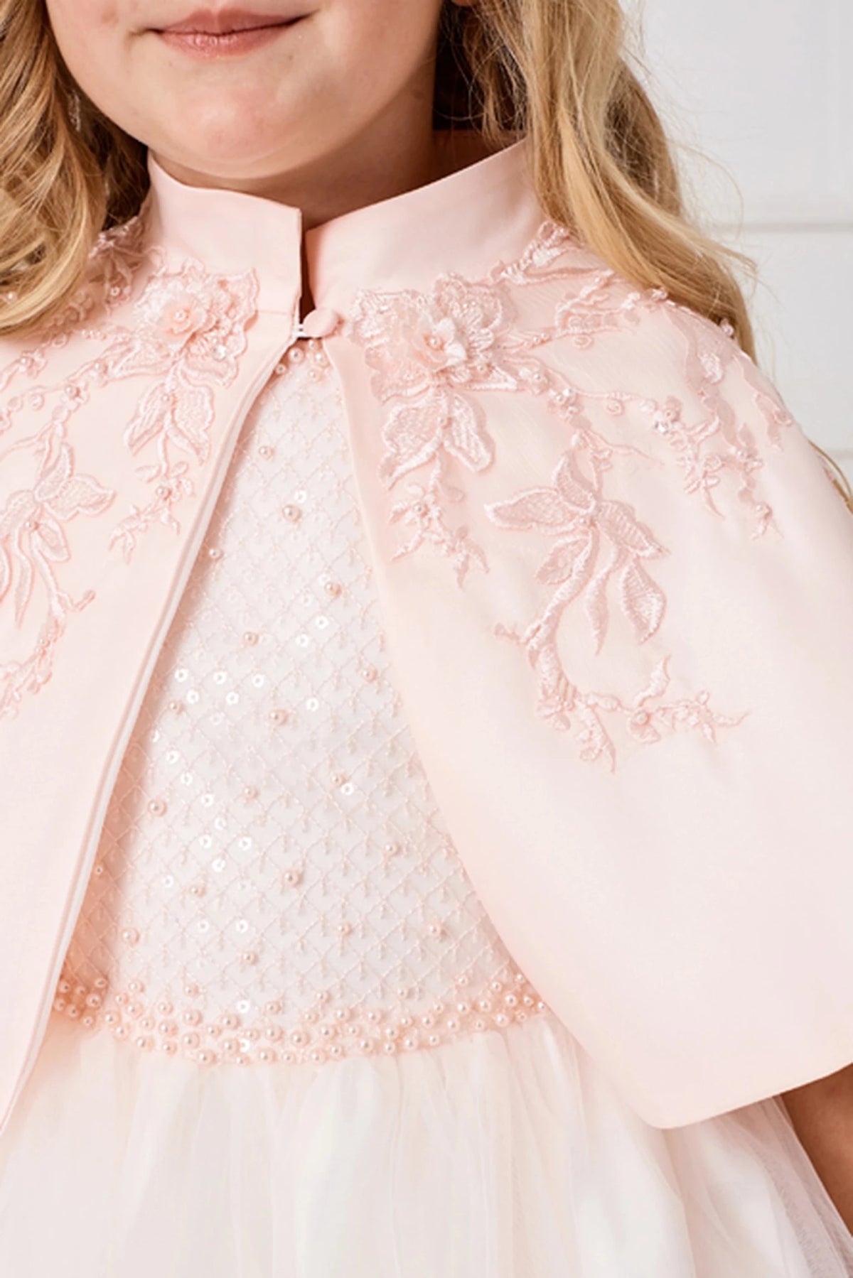 Appliqué detail around the Blush satin cape neckline.