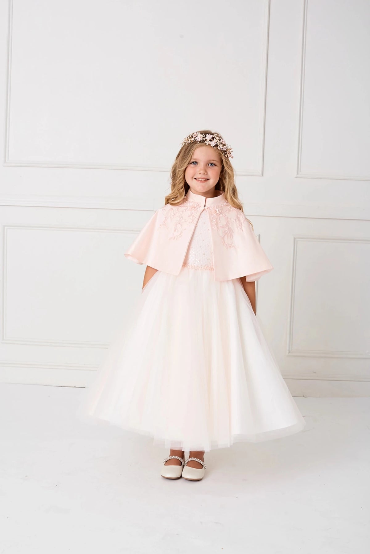 Draped Blush satin cape with floral appliqué around the neckline.