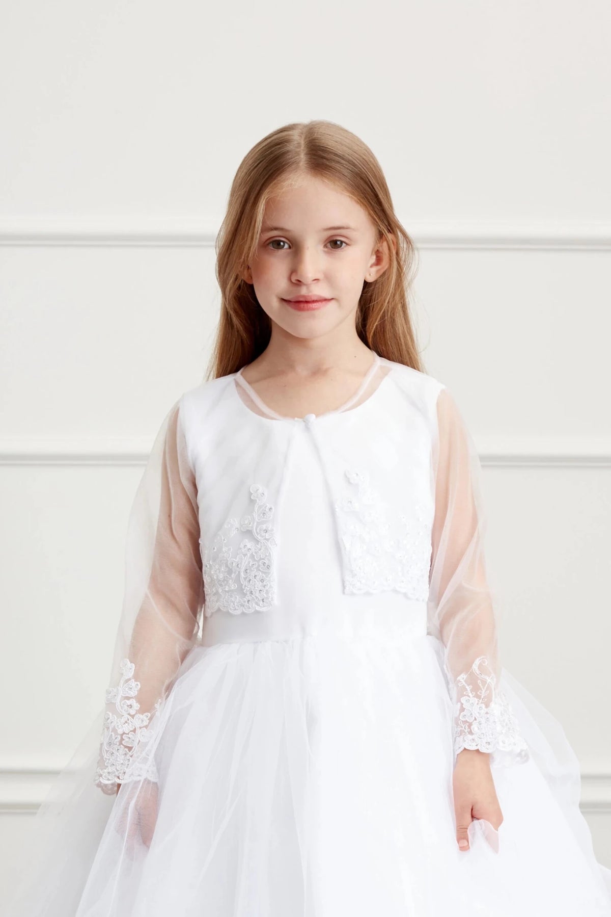 White bolero jacket with long sleeves and lace appliqué.