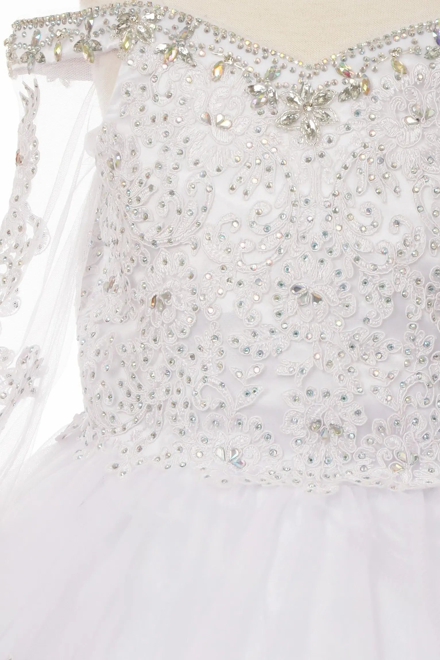 Rhinestones detail of a white kids mini quinceanera dress with AB stones glitter tulle fabric and scattered floral appliques