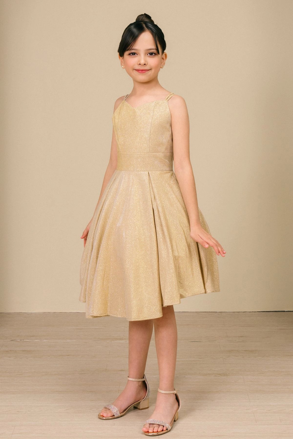 Accented metallic skirt pleats adds character to this Gold kids party dress.
