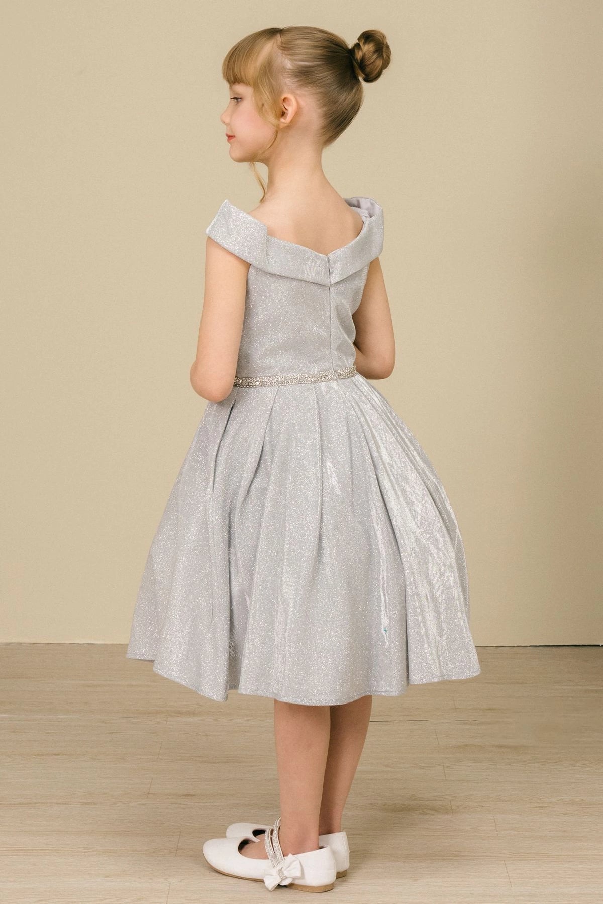 Finished details of a folded off-shoulder neckline distinguish the Silver kids party dress.