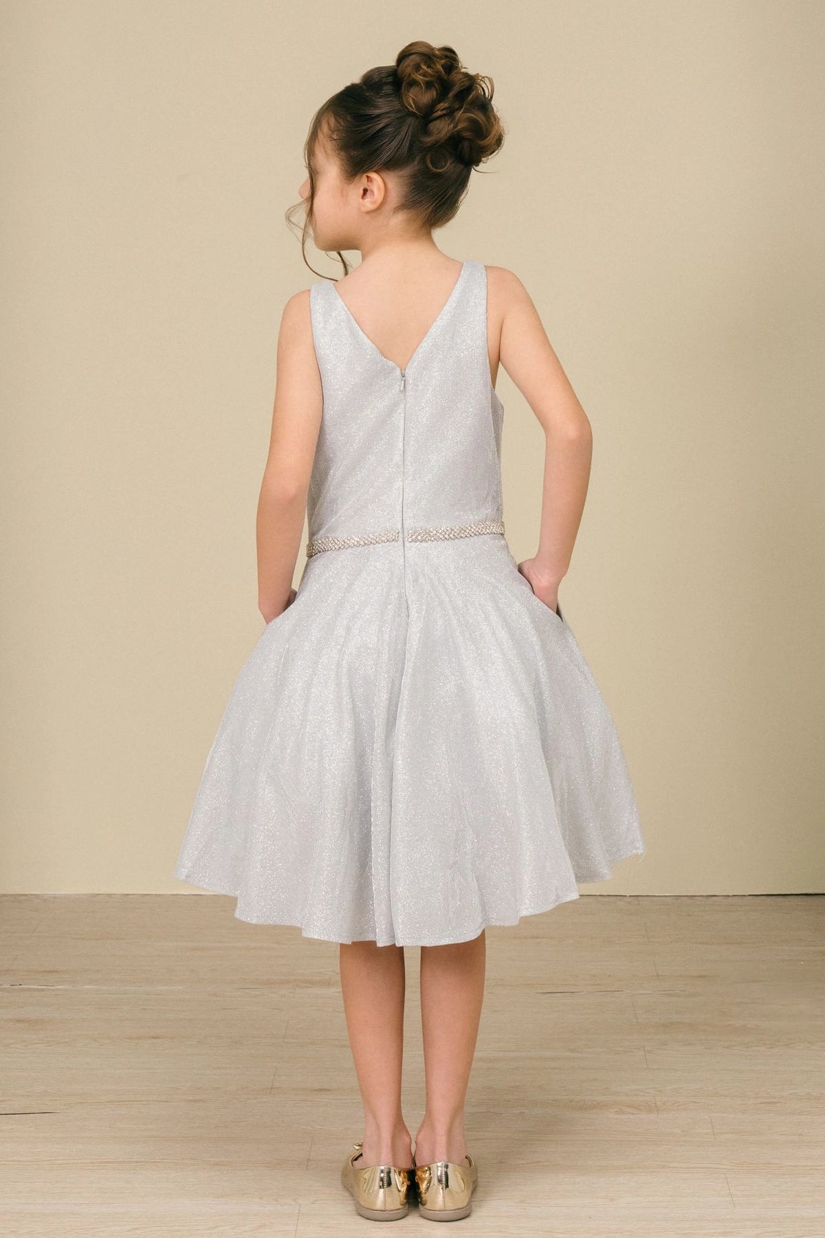 Finished details of a V-shaped back distinguish the Silver kids party dress.