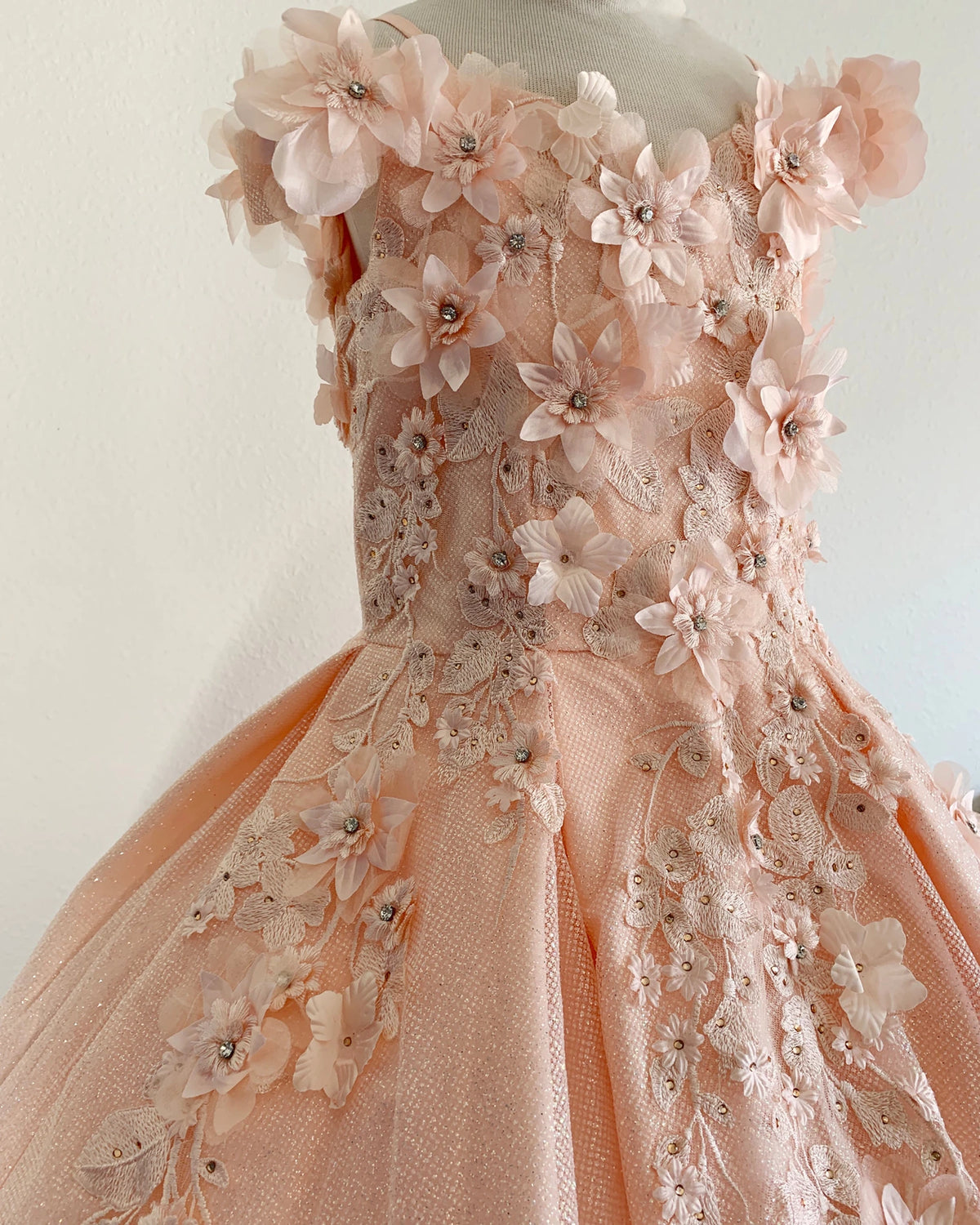 Peach blush front view kids mini quinceañera mini quince dress with floral lace embroidery and satin tulle fabric.
