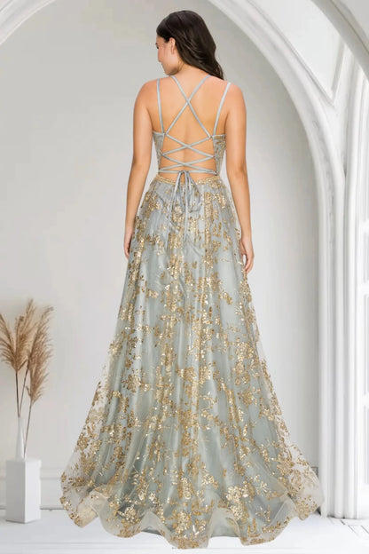 A full back view of a woman wearing a silver formal dress with a lace-up open back and train.