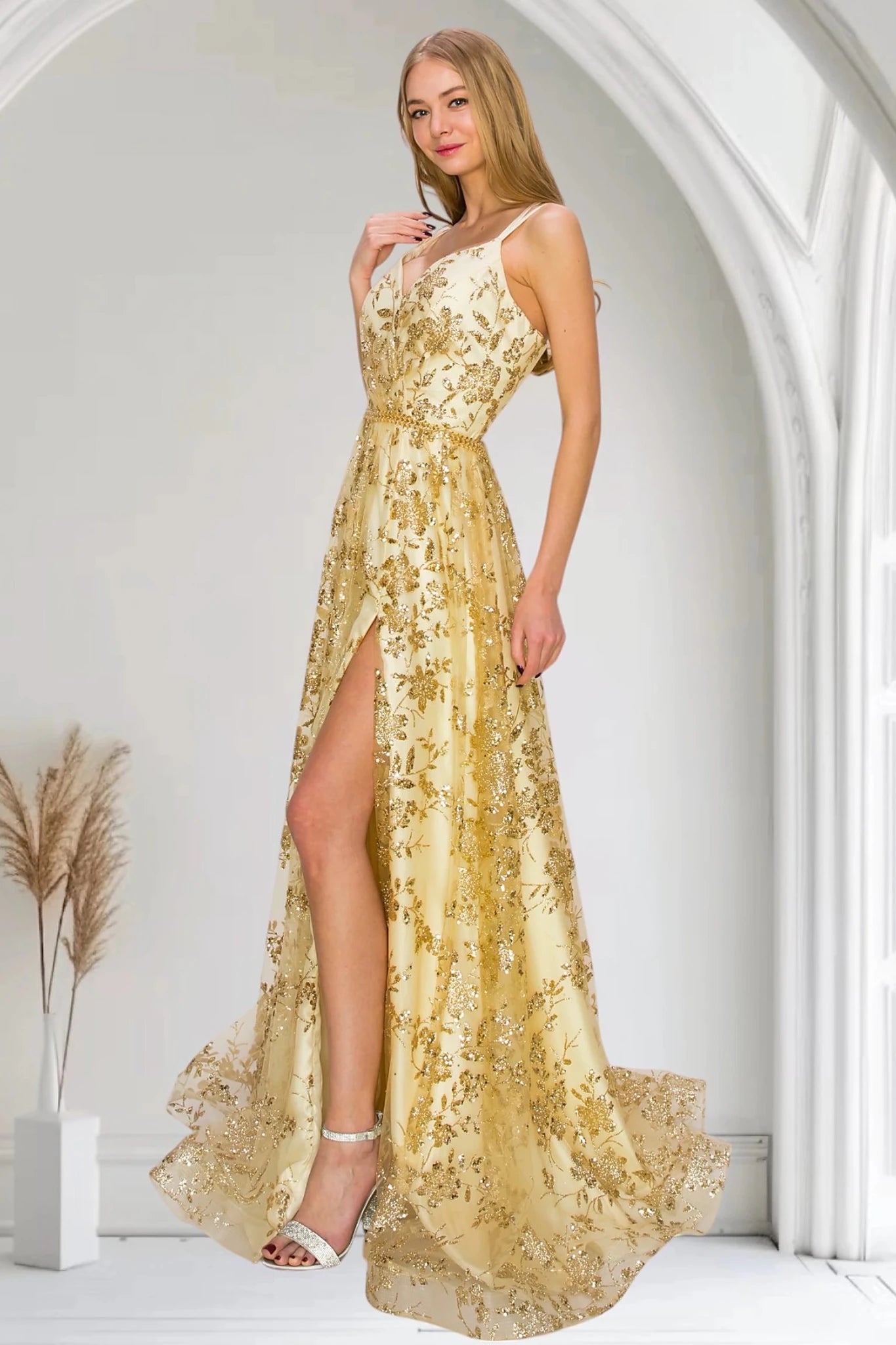 Champagne evening dress with V-neckline framed by dual spaghetti straps