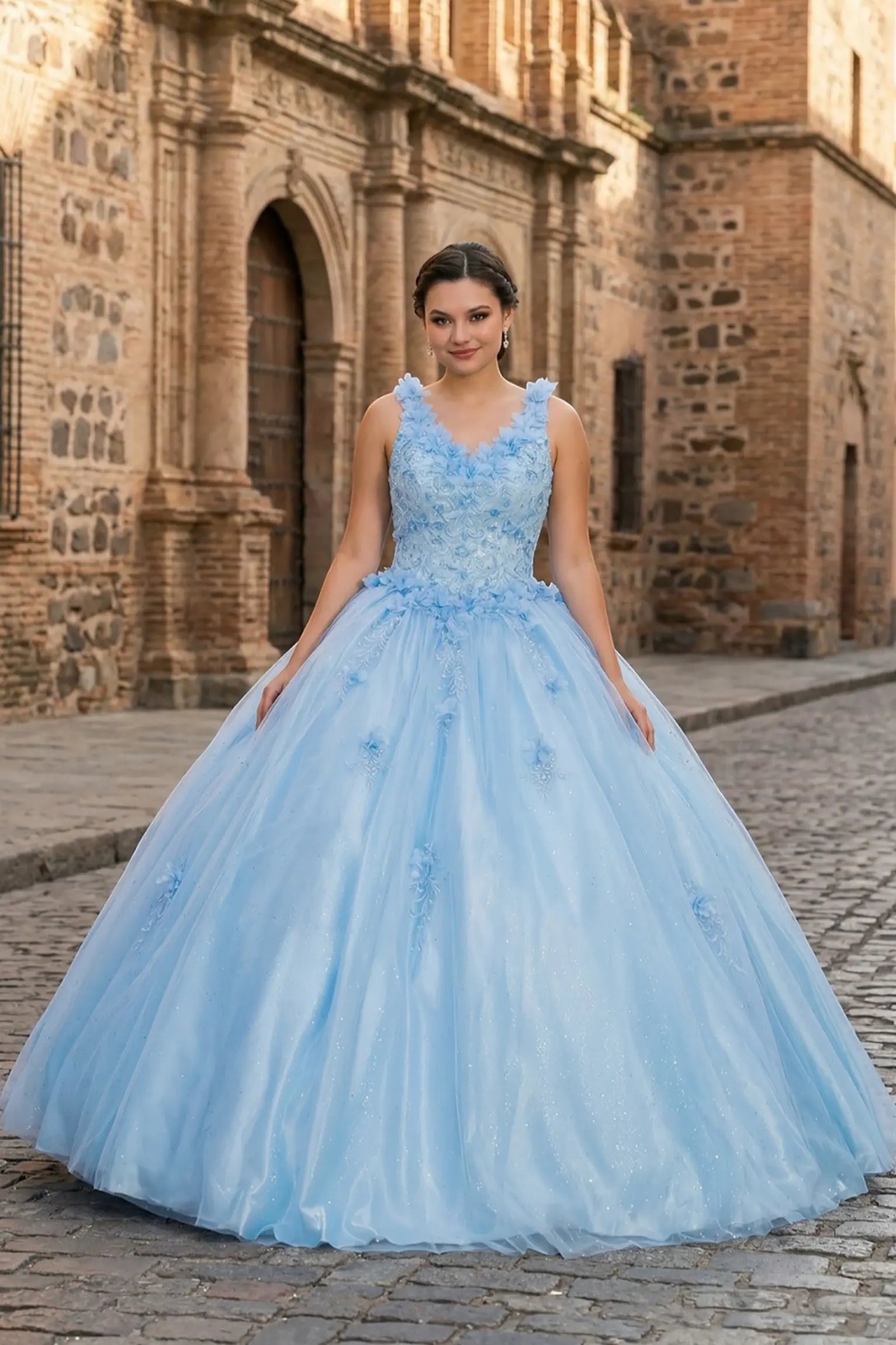 Front view of a blue quinceanera dress with V-neckline, 3D floral appliques, sleeveless bodice, and layered glitter tulle skirt