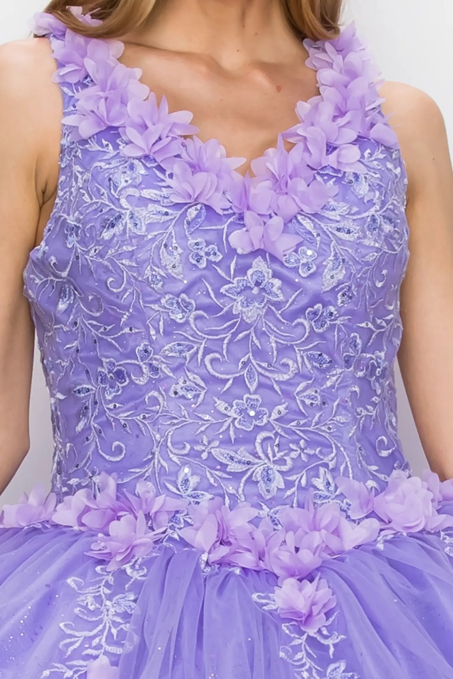 Zoomed front view of a lilac quinceanera dress highlighting 3D floral appliques, beadwork bodice, and glitter embellishments