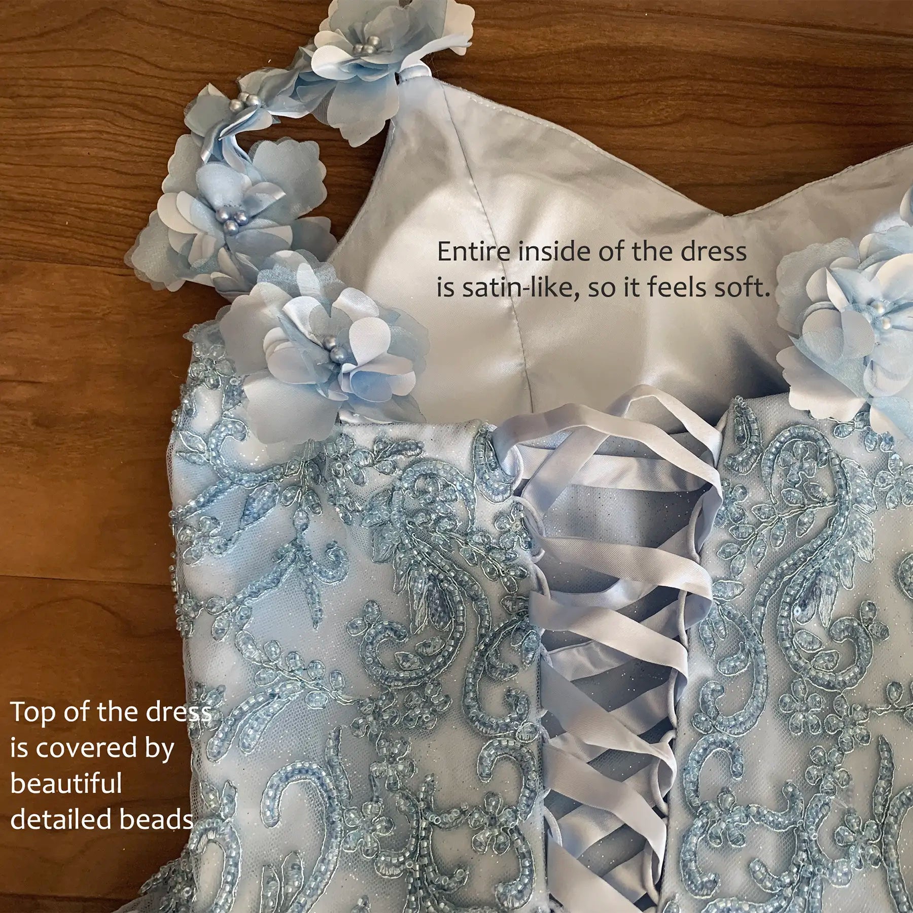 Close-up of blue mini quince dress with beaded floral bodice stones and pearls decoration detail