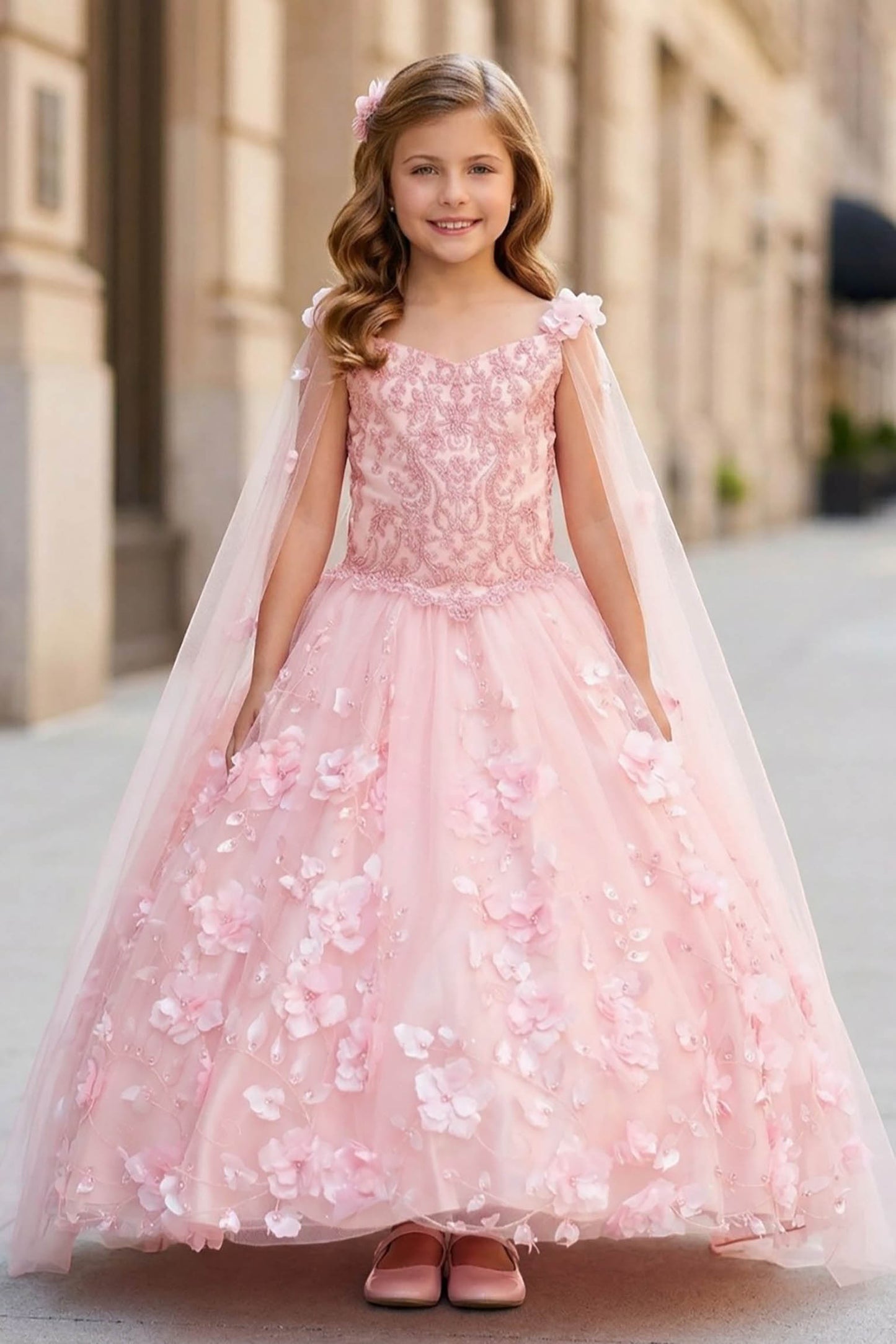 Front view of blush mini quince dress with 3D flowers stones pearls detachable cape and layered skirt.