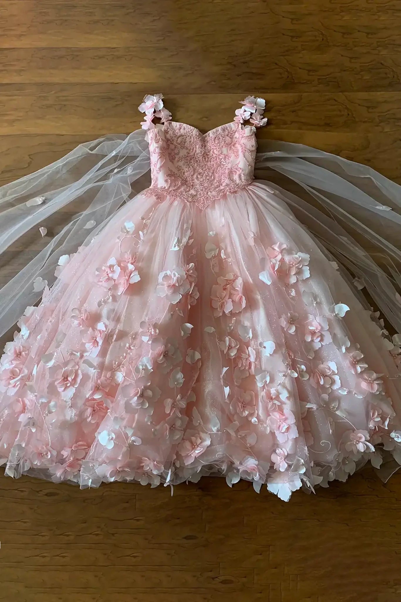 Blush mini quince dress with floral applique and train detail.