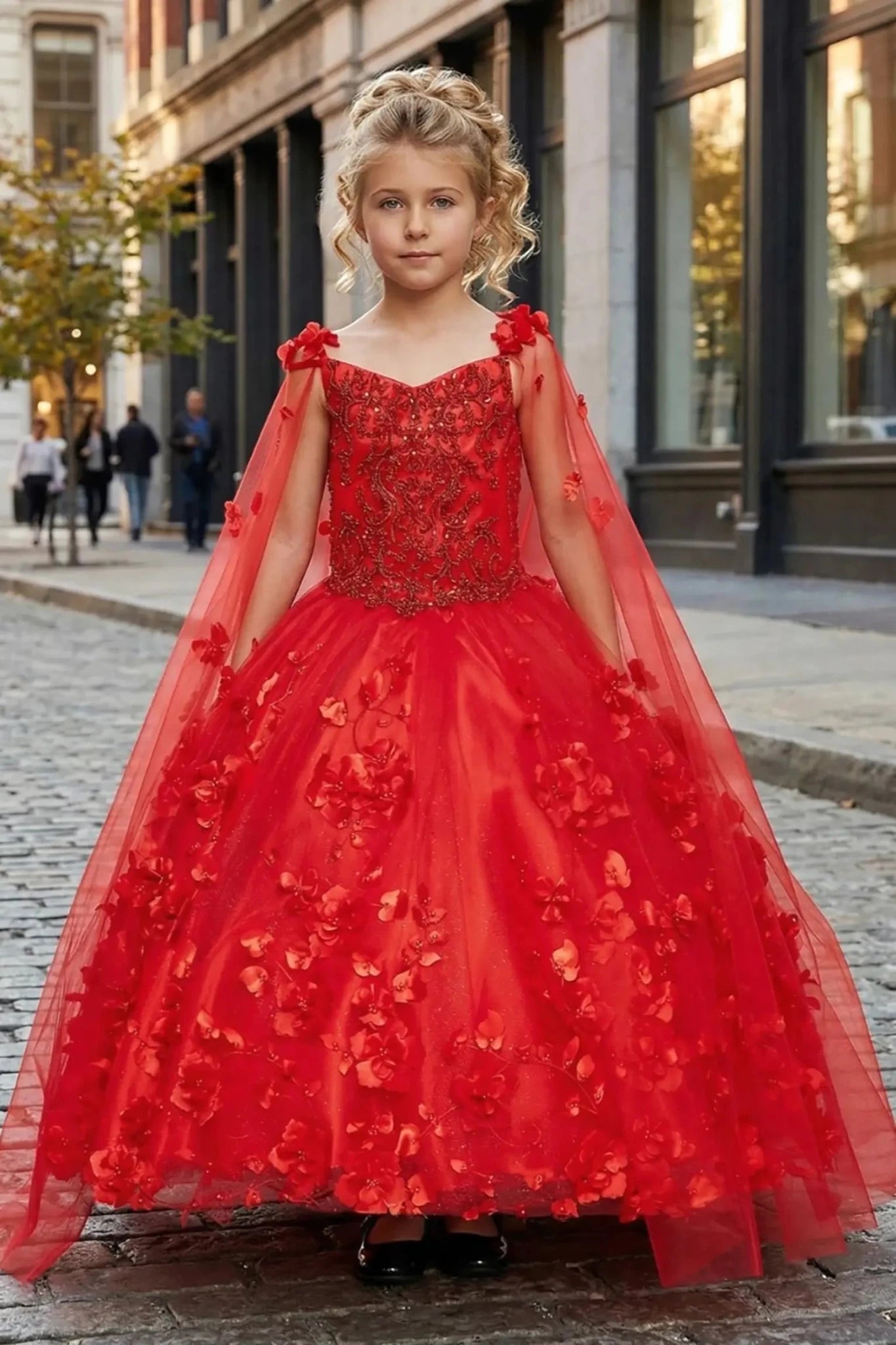 Red front view kids mini quinceañera mini quince dress with 3D floral applique, stones, pearls and detachable cape.
