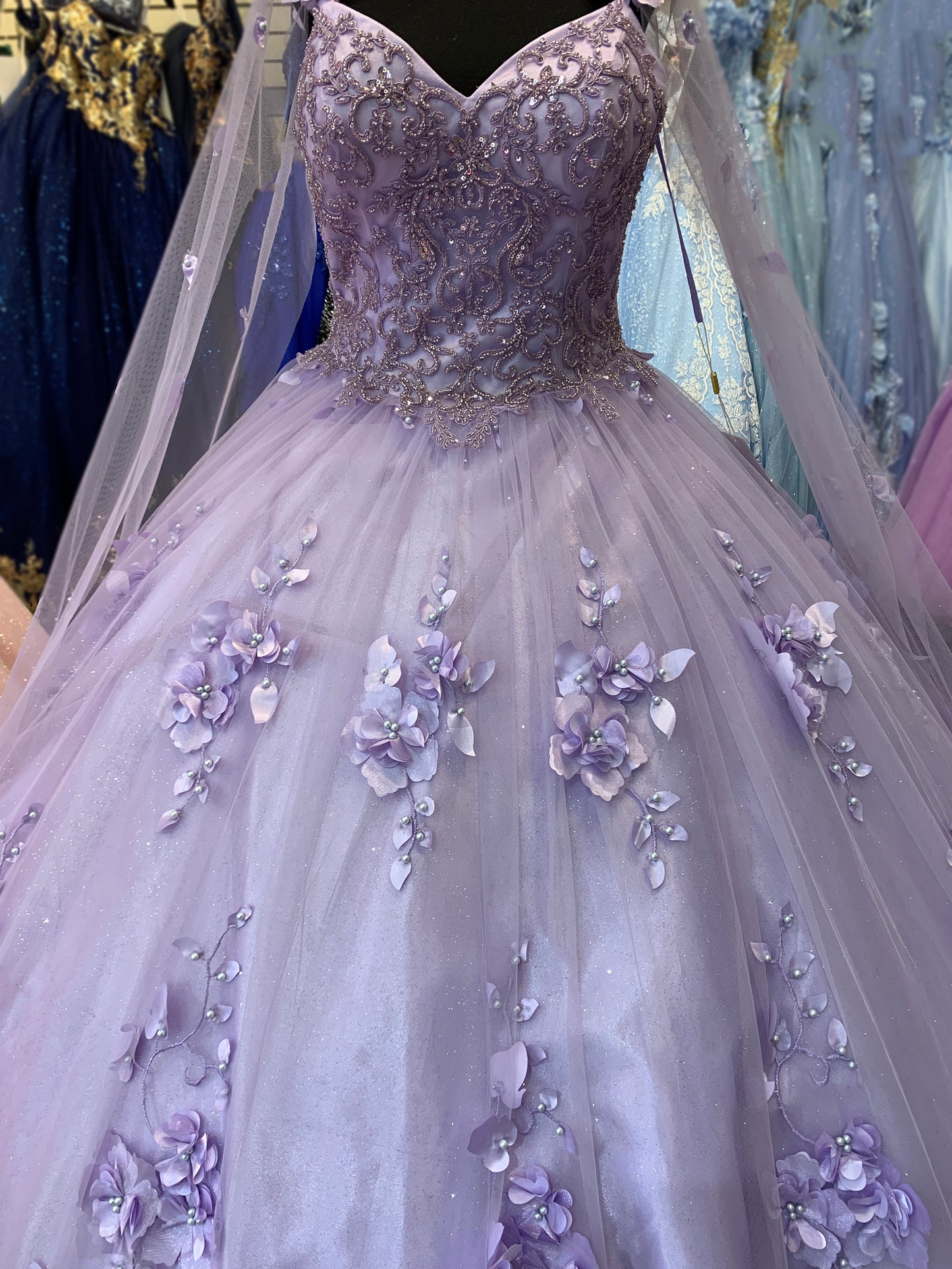 Lilac Quinceanera | Elegant 3D Stone & Pearl Embellishments, Floral Appliques Ball Gown with Detachable Cape - front view of dress showing detailed pattern