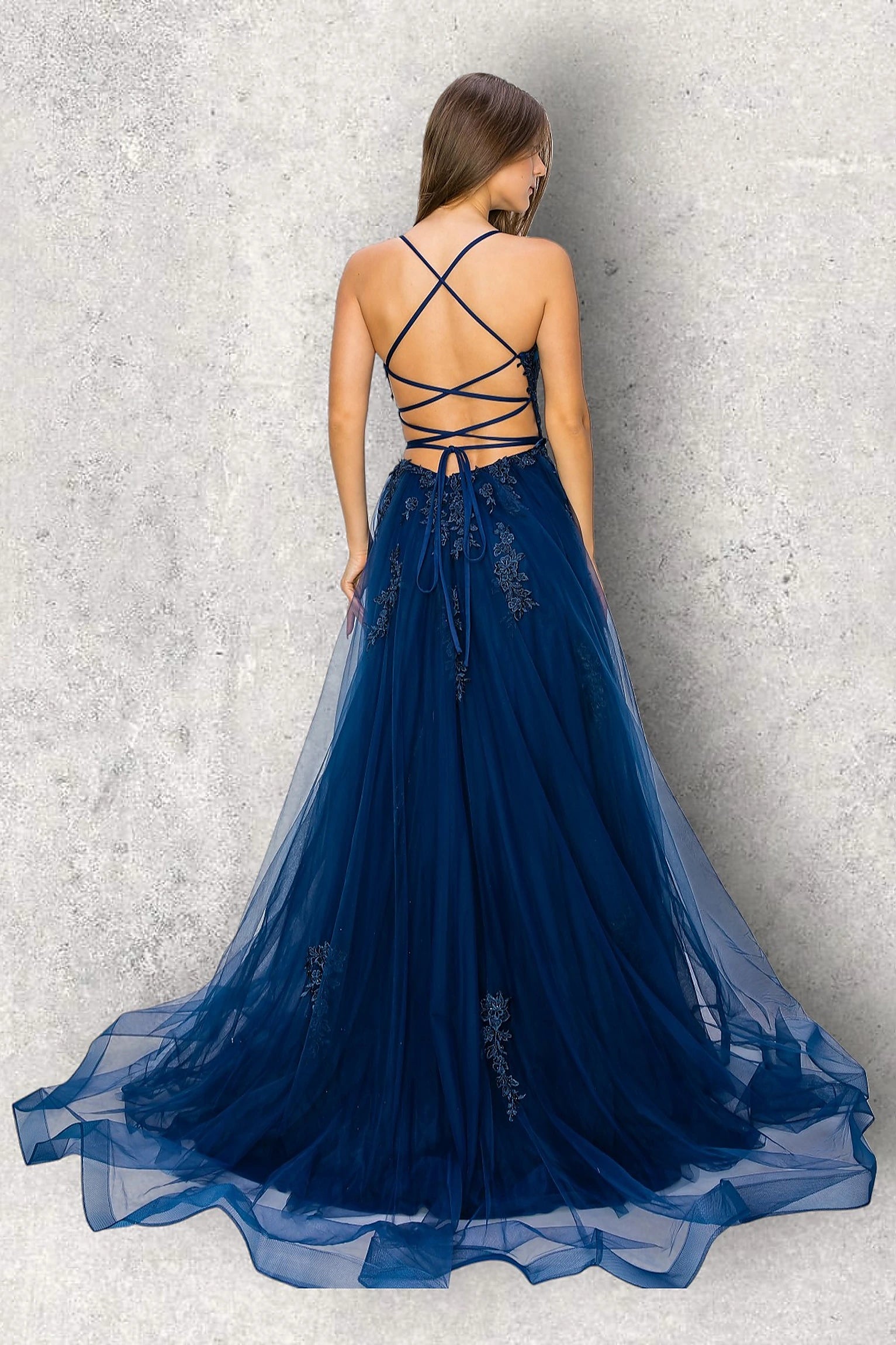 Navy evening dress featuring thin straps and crisscross open back