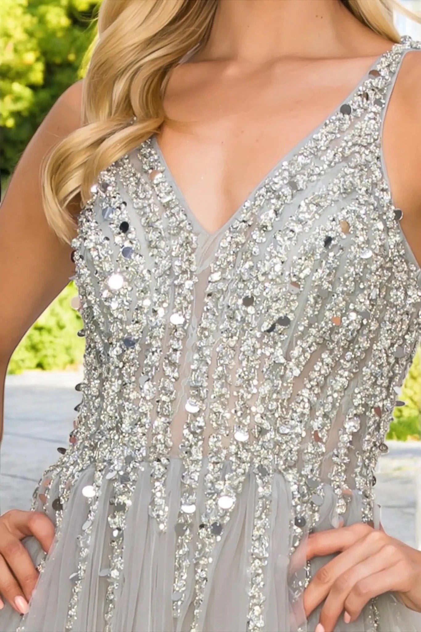 Close-up of silver lace bodice with sequin embellishment.