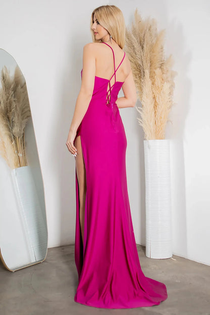 A full-length view of a woman wearing fuchsia formal dress with lace-up corset closure.