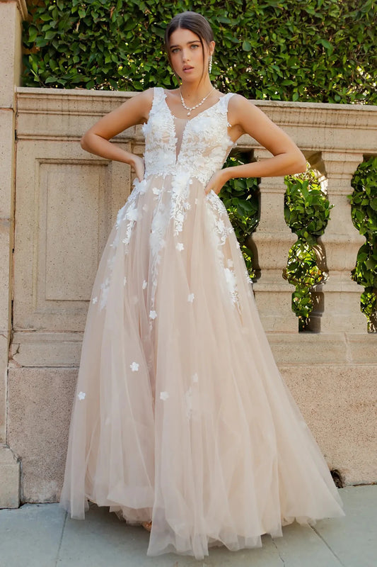 Full front view of a women wearing champagne floral lace A-line prom dress with illusion V-neck bodice and flowing skirt.