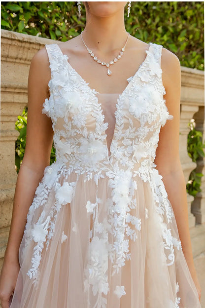 A close-up view of a woman wearing a champagne lace bodice with pearl beads and 3D organza floral detail.