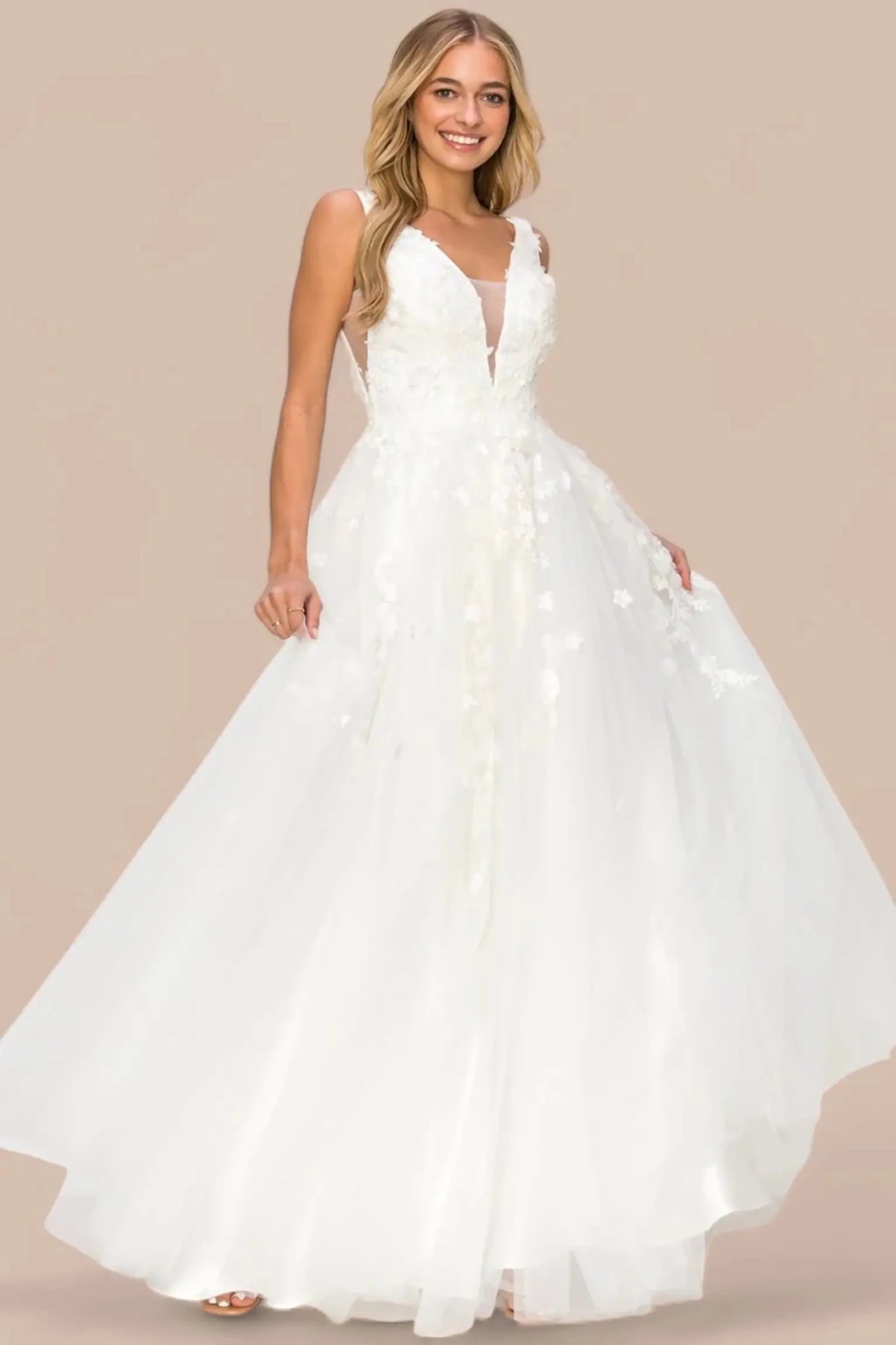 Full length- view of silver formal dress featuring deep V-length- and flowing skirt.