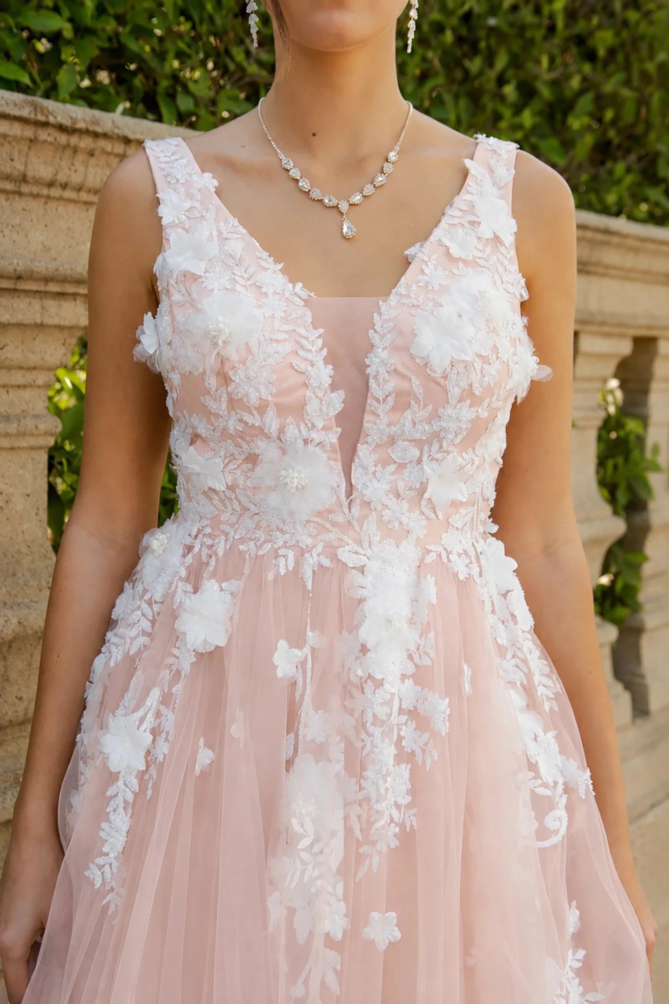 a blush pink and white floral lace dress with a deep V-neckline