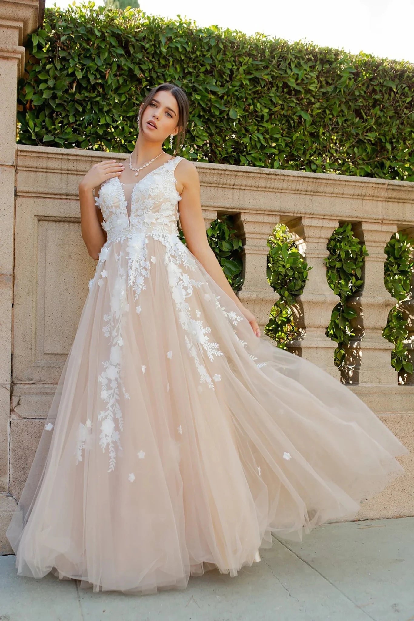 Woman in a beige champagne floral tulle gown