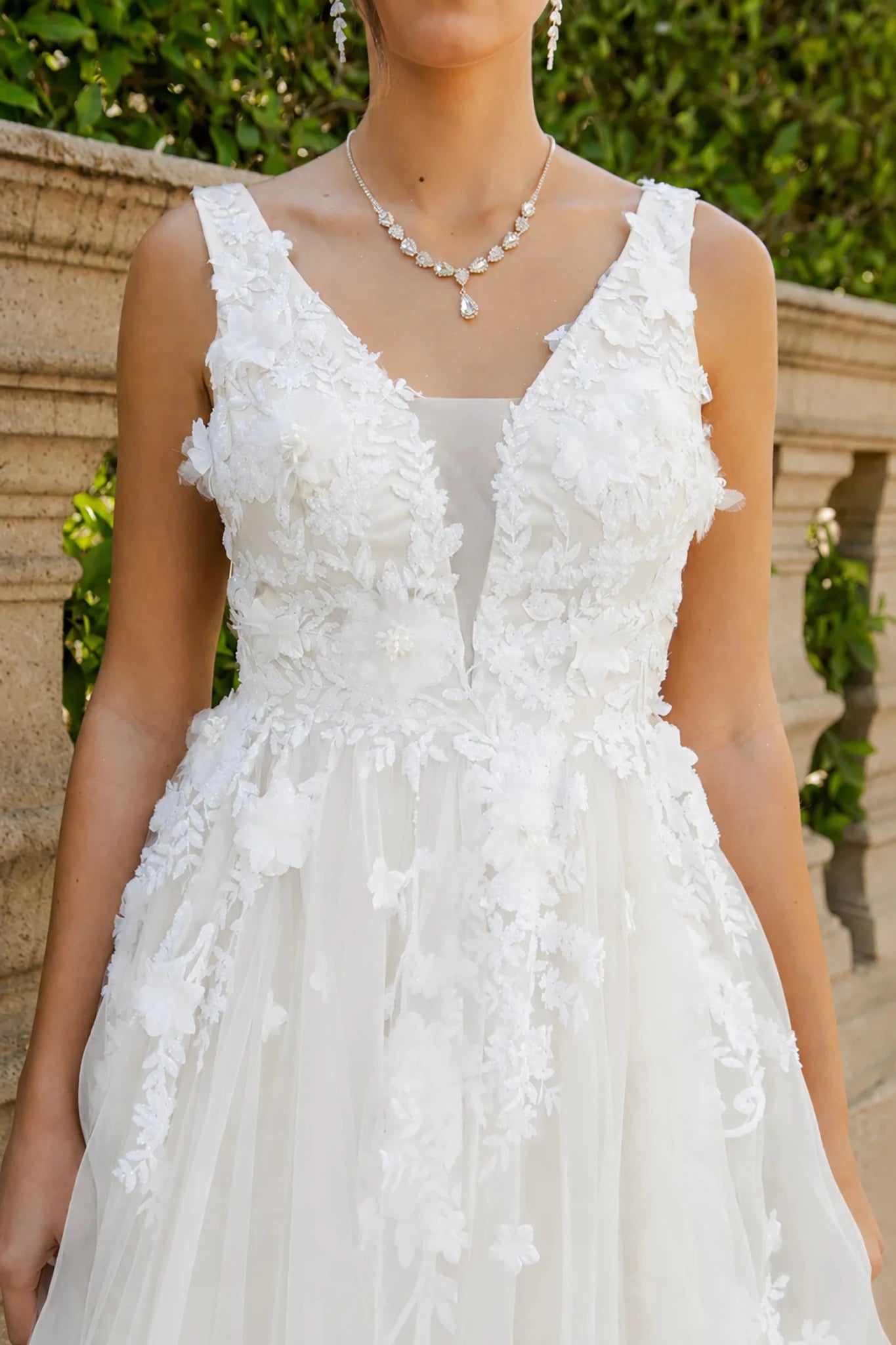 a dress with 3D floral applique bodice and a V-neckline 