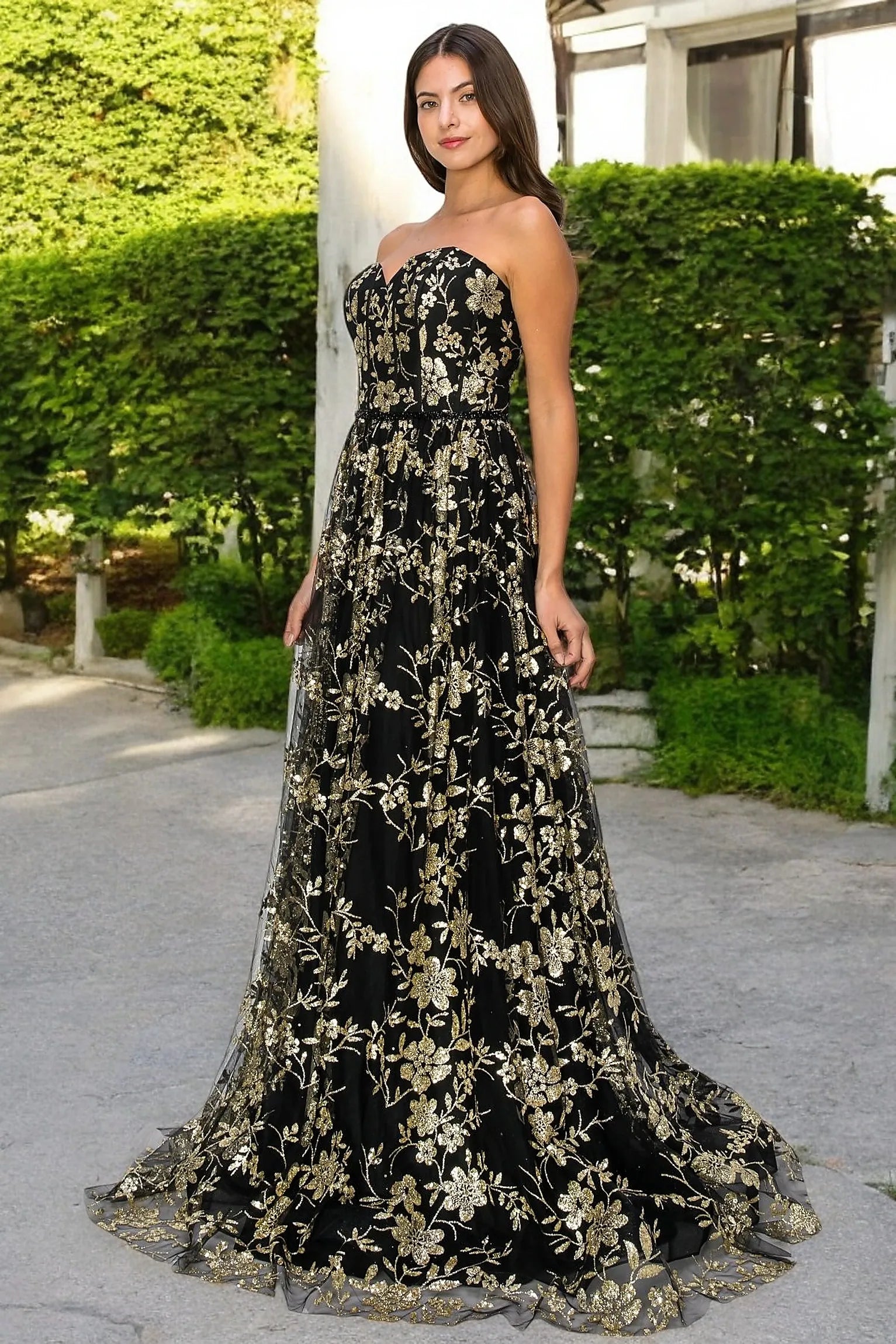Black evening dress showcasing floor-length A-line skirt with sheer glitter overlay