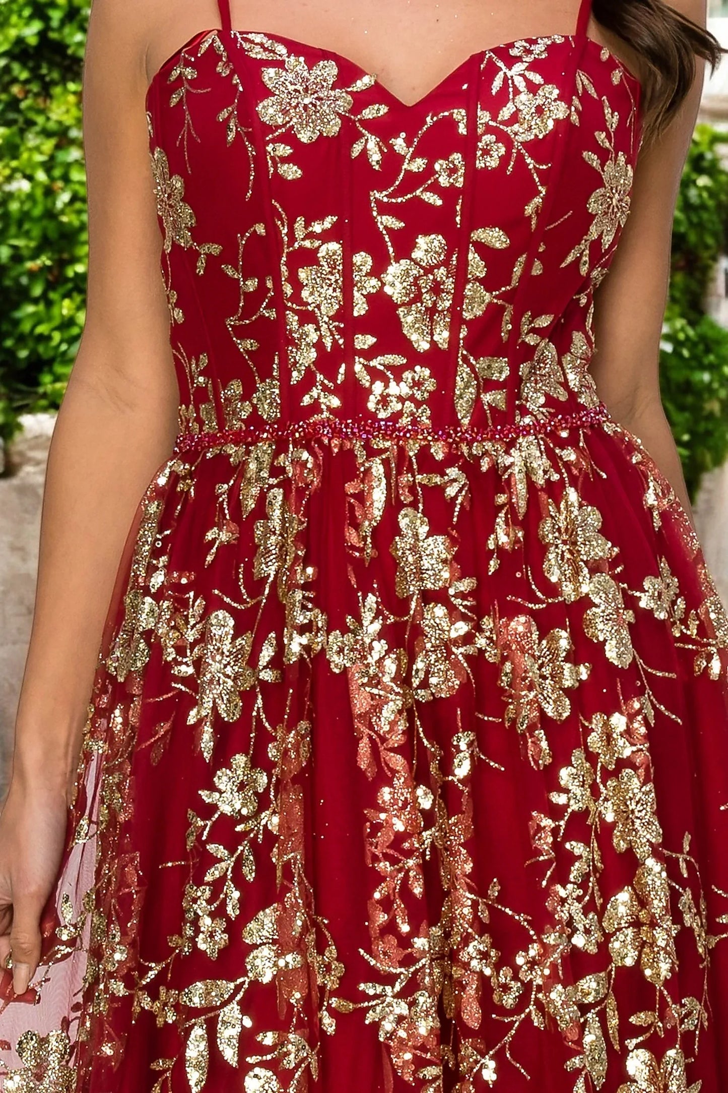 Burgundy evening dress featuring glitter gold floral print across bodice and skirt