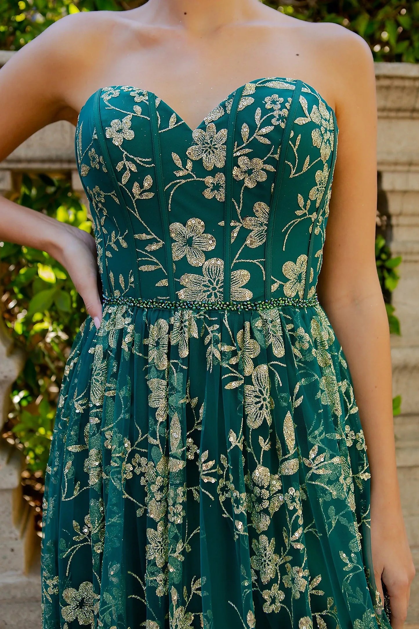 Green evening dress featuring glitter gold floral print across bodice and skirt