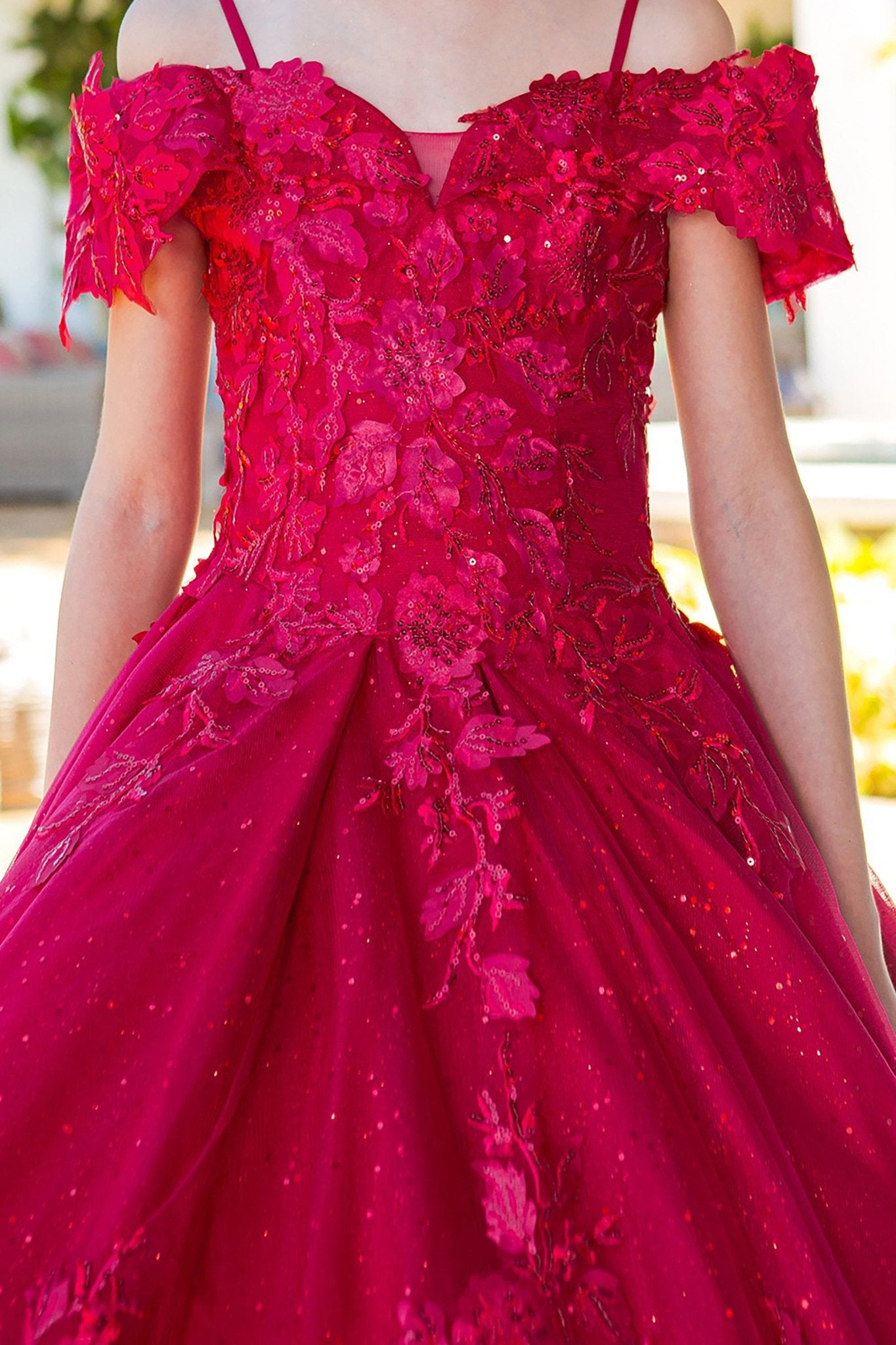 Red close-up front view kids mini quinceañera mini quince dress with sweetheart neckline, glitter lace bodice and 3D floral sequin applique.