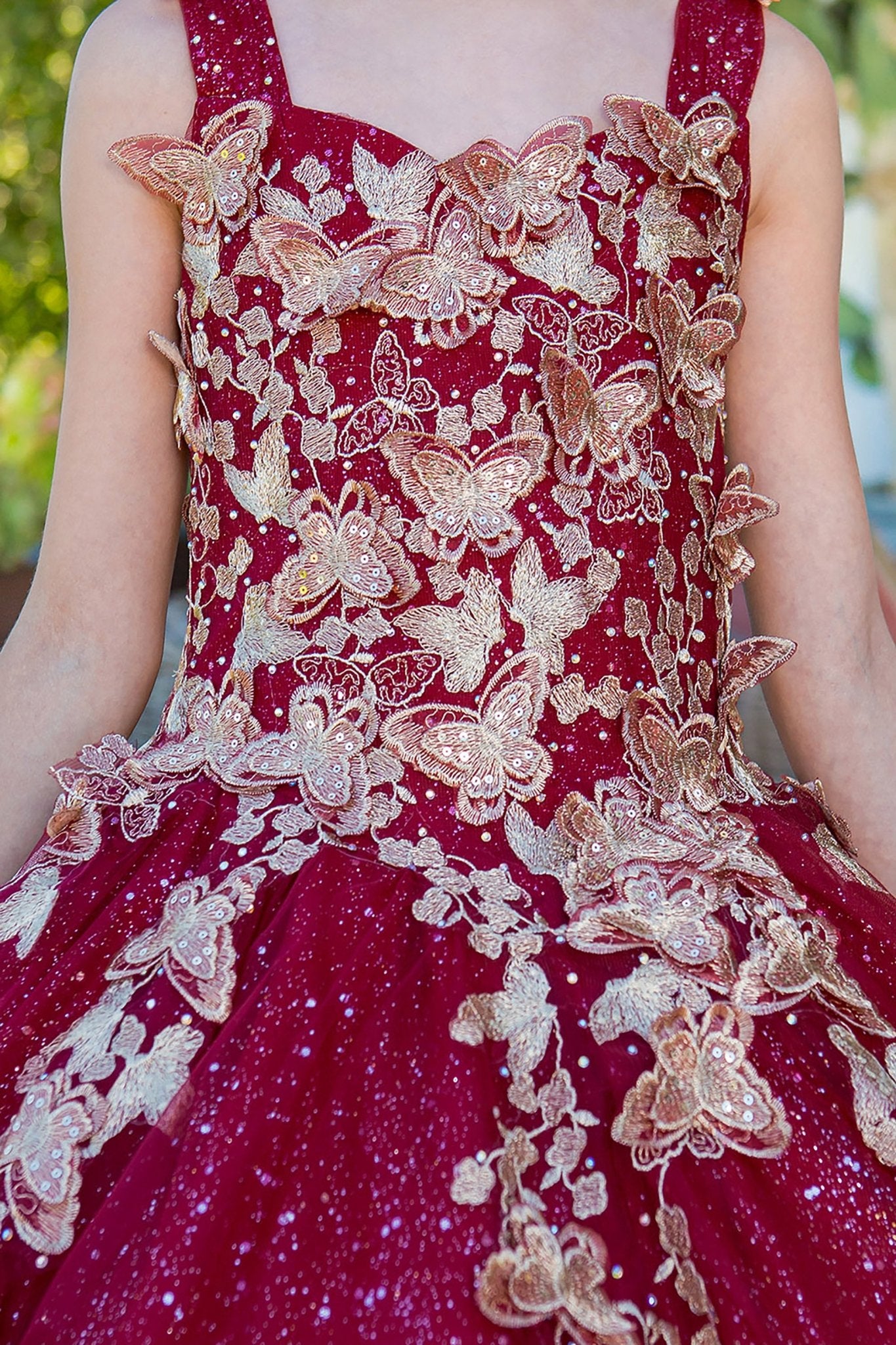 Burgundy mini quince dress with metallic 3D butterfly glitter tulle front zoom detail.