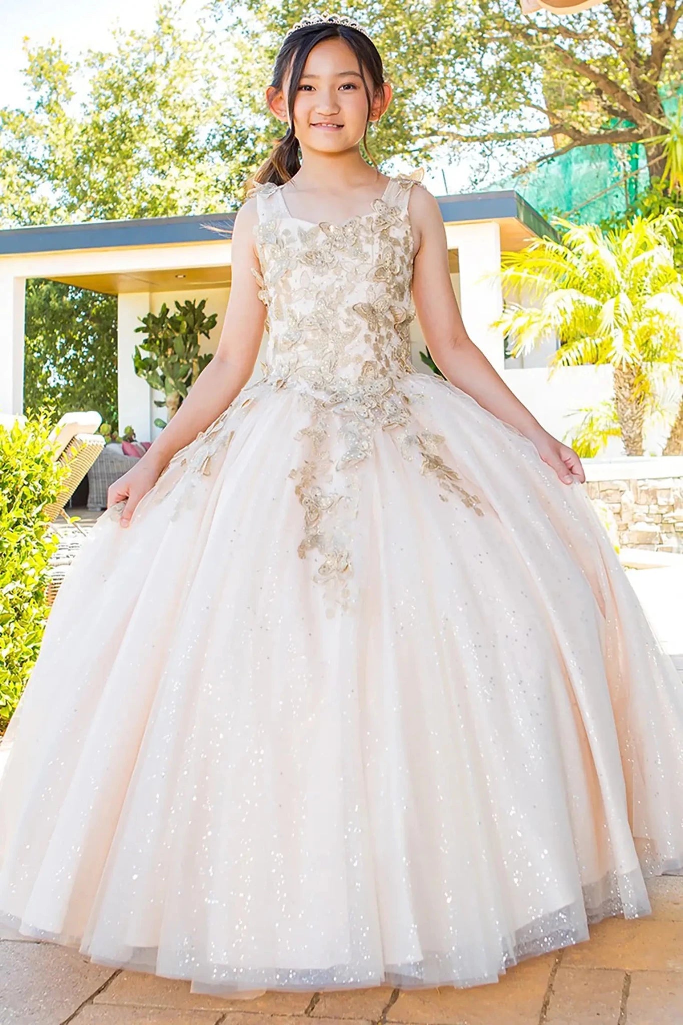 Front view of champagne mini quince dress with metallic 3D butterfly glitter tulle fitted bodice and A-line skirt.