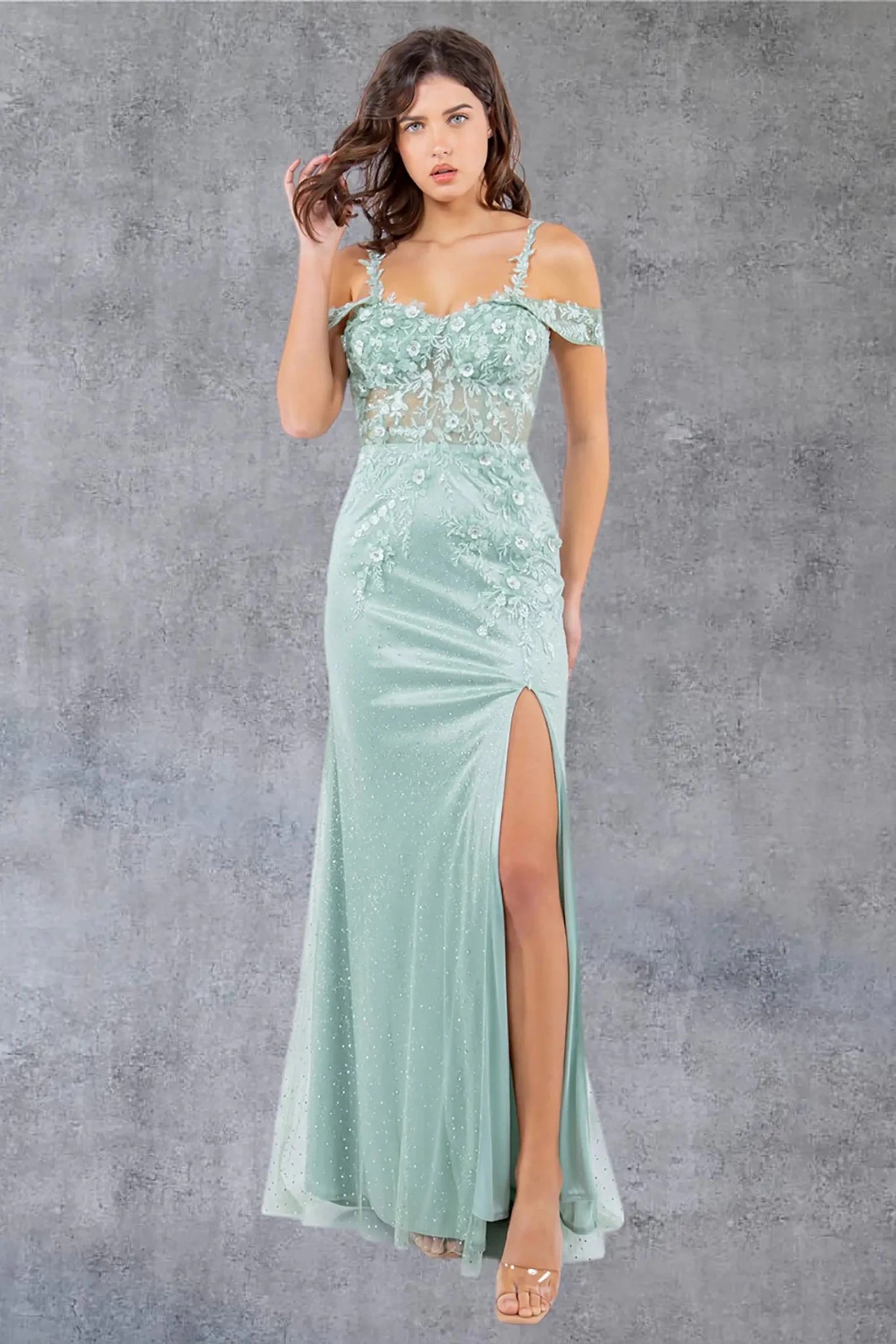 Full front view of a women wearing sage off-shoulder tulle prom dress with AB stones and floral appliqués.