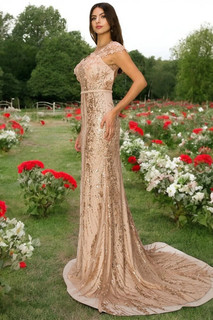 A full-length view of a woman wearing rose gold formal prom dress with open back detail.